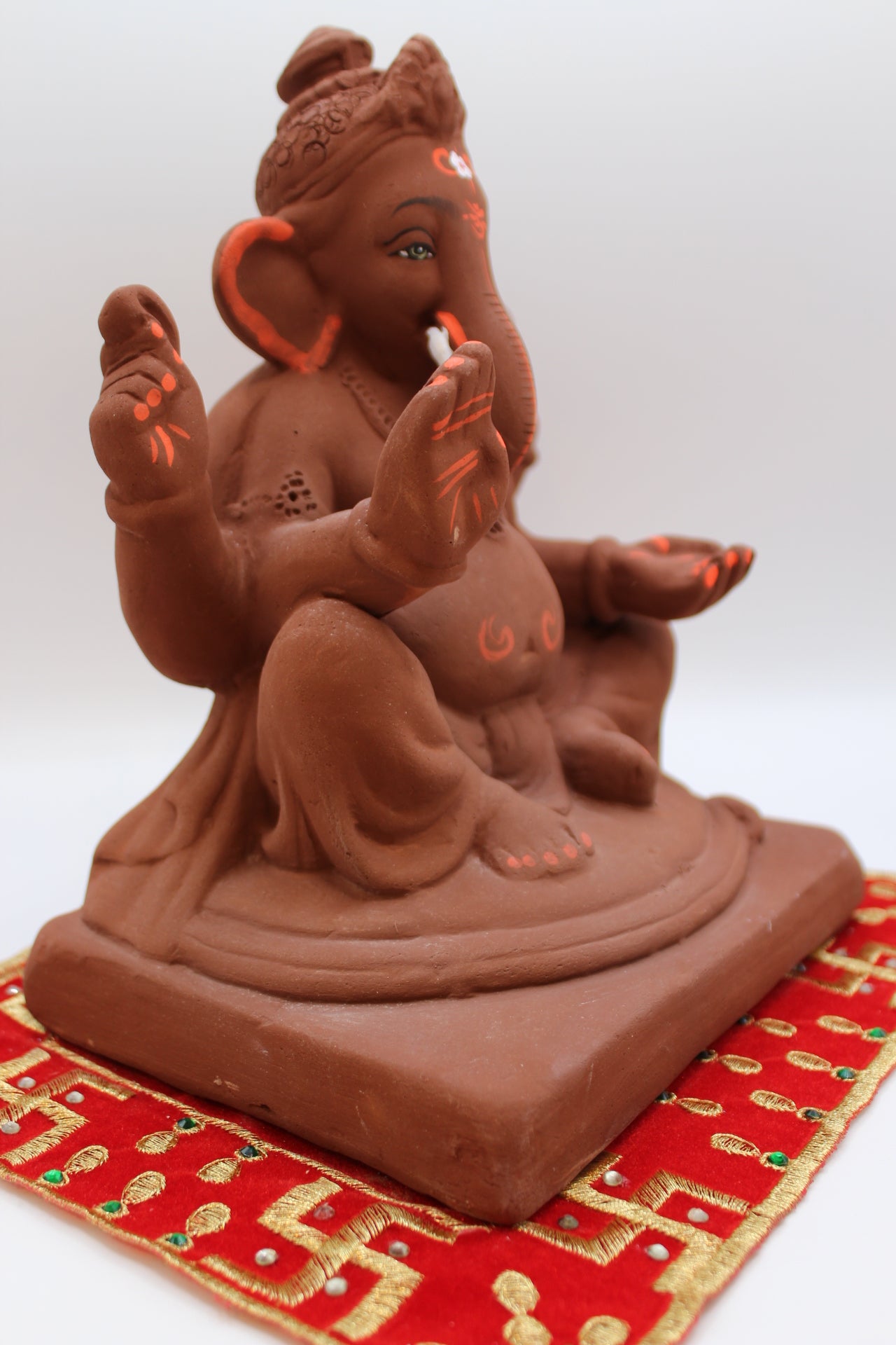 Natural terracotta eco-friendly 8 inch Ganesh Visarjan idol with bun topknot – side view