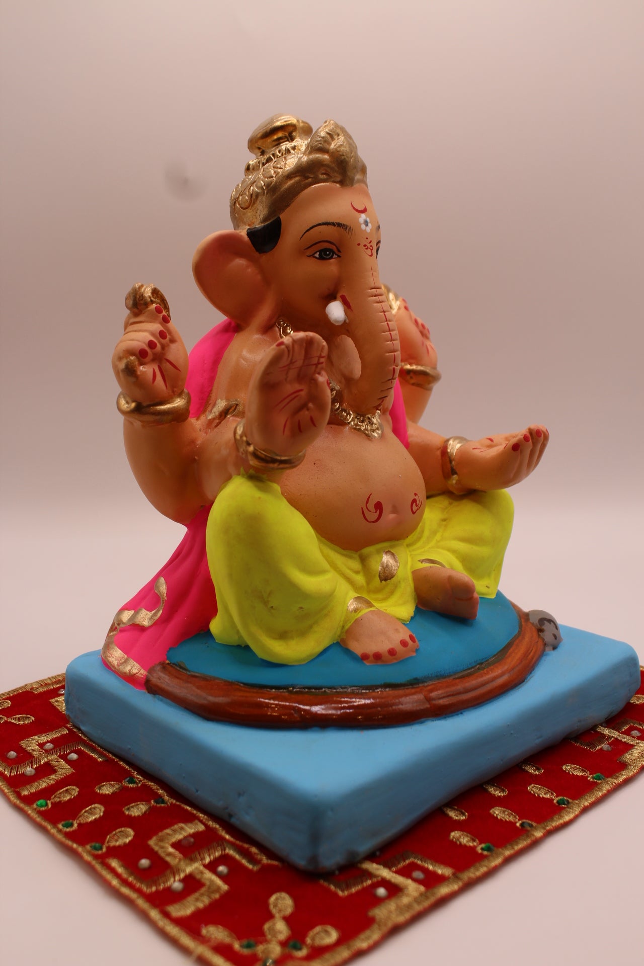 Eco-friendly 8 inch Ganesh Visarjan idol in pink shawl and lime dhoti – side view