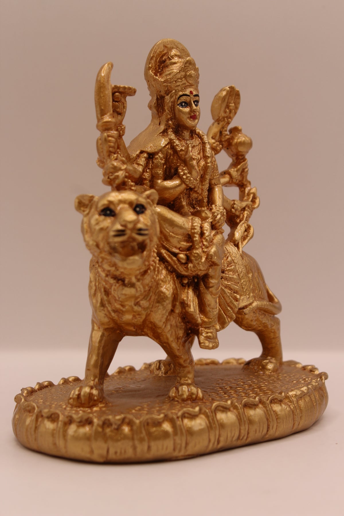 Gold Ambe Maa on lion statue, left side