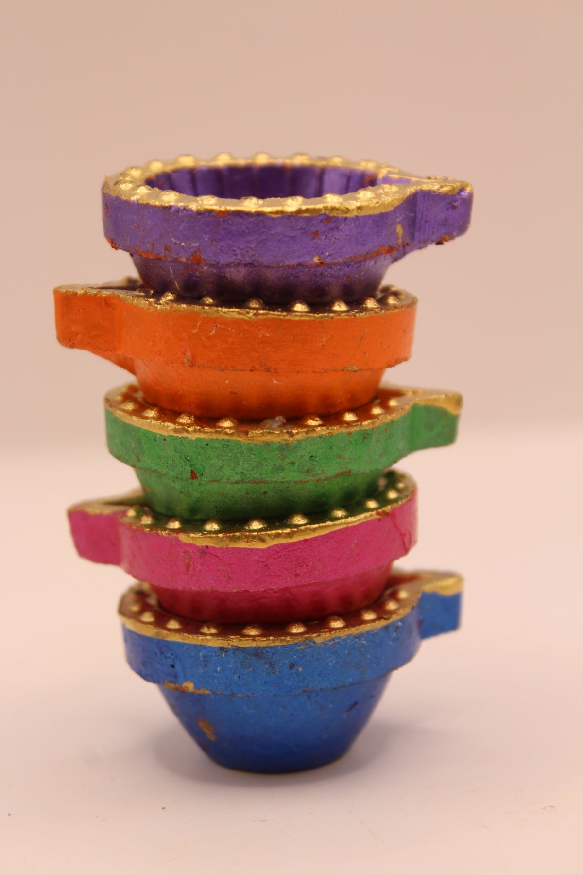 Painted clay diyas stacked