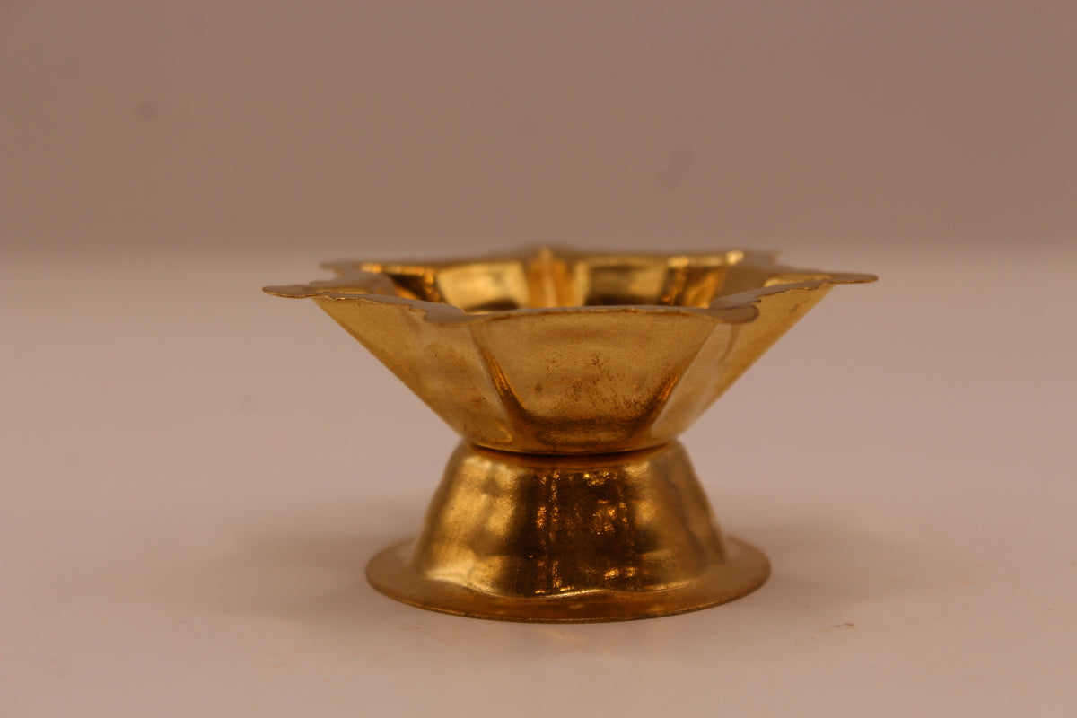 Small gold metal diya, side