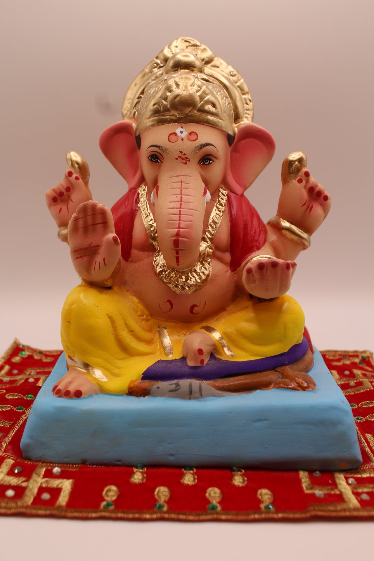 Eco-friendly 8 inch Ganesh Visarjan idol in red blouse and yellow dhoti with gold fan crown – front view