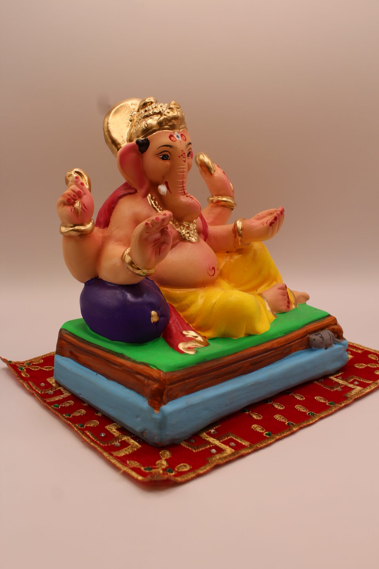 Eco-friendly 8 inch Ganesh Visarjan idol in rose shawl and yellow dhoti – side view