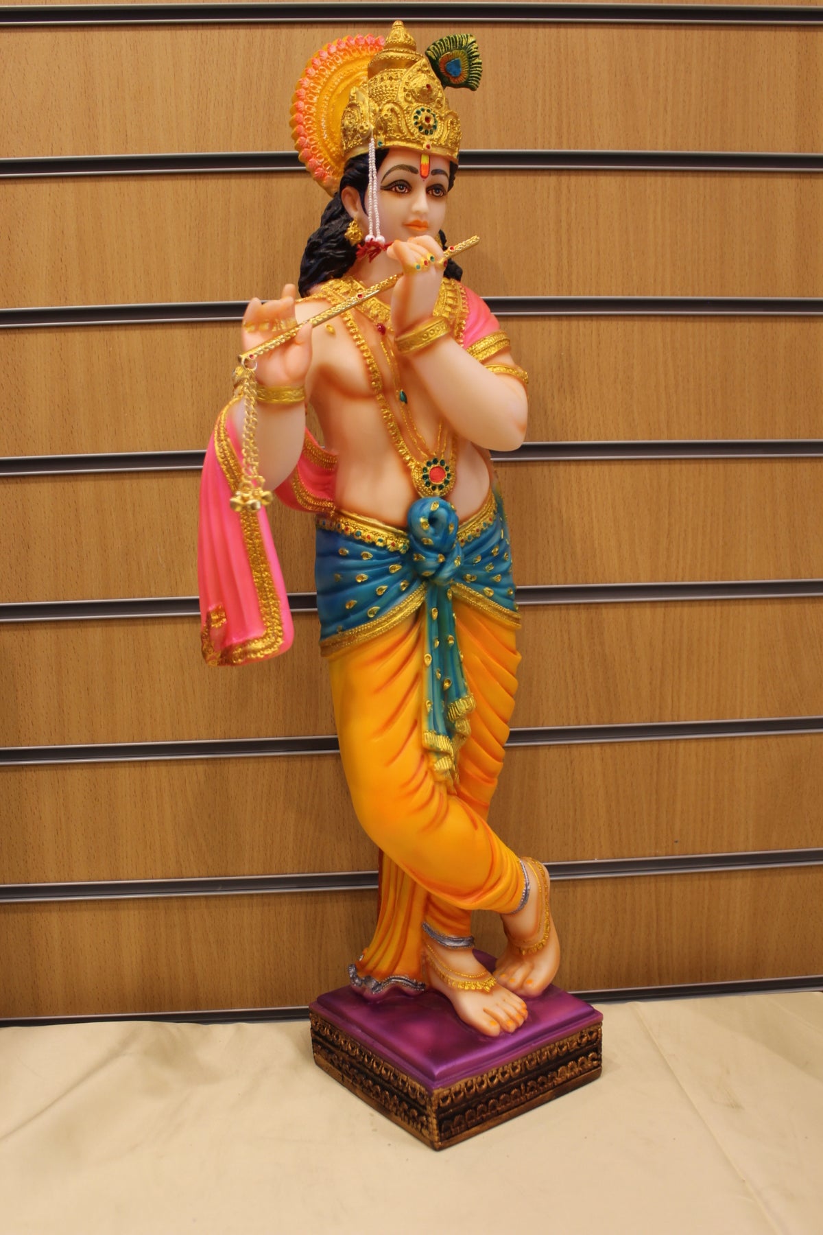 Resin/Fibre Krishna Statue for Home Temple – Playing Flute, 25 inch – Orange & Teal – left side view