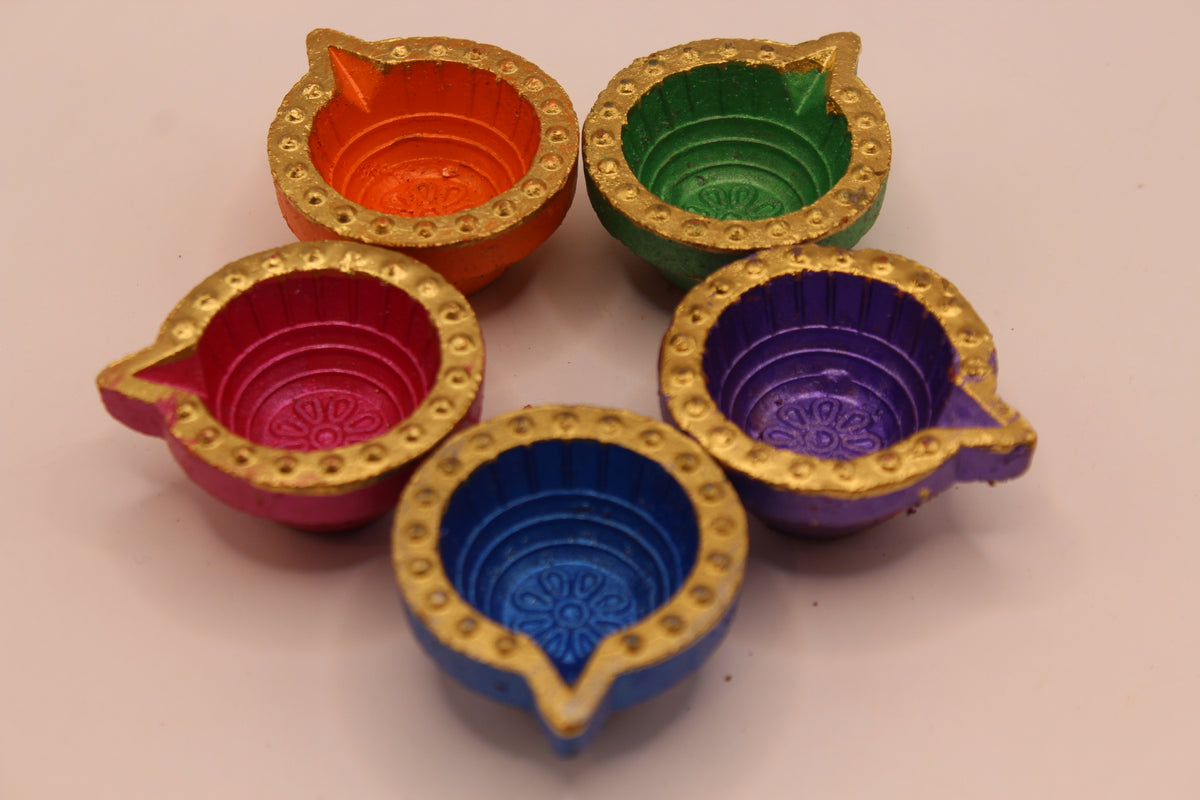 Painted clay diyas, side view