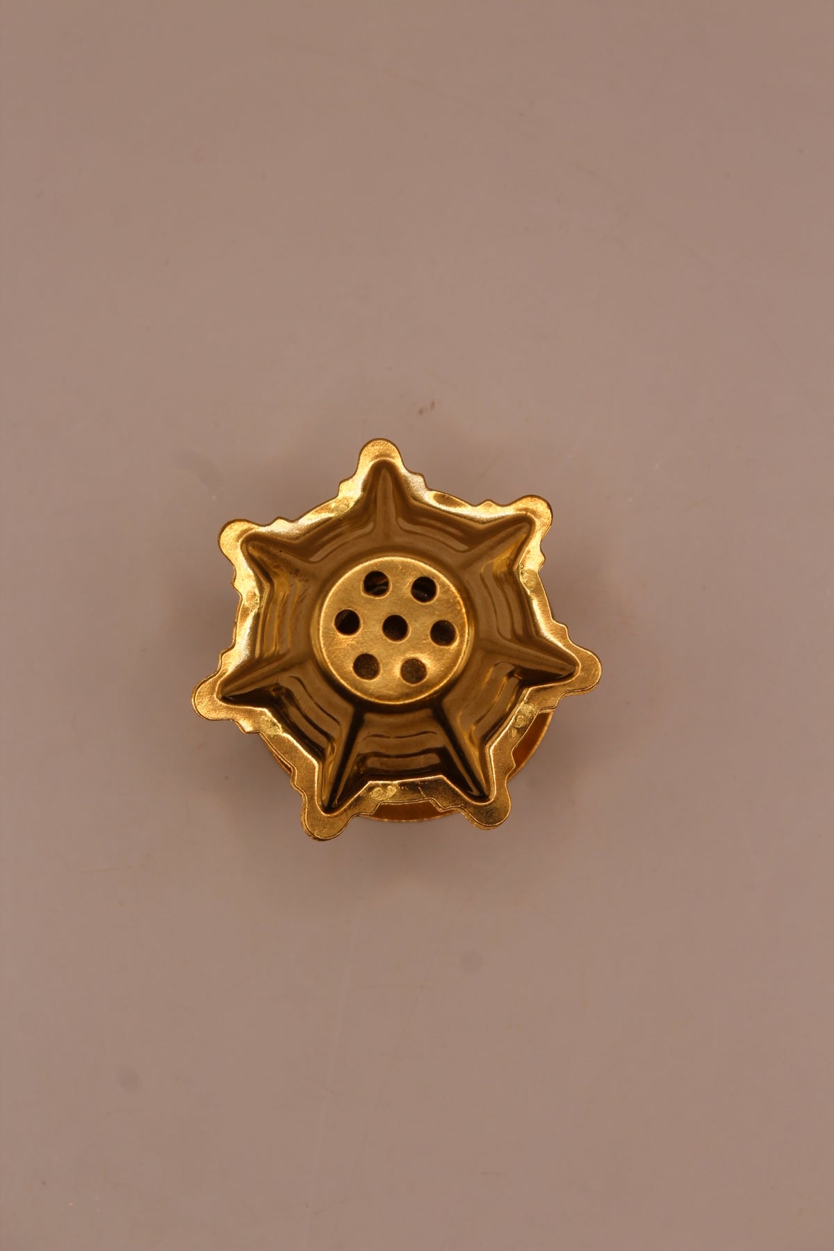 Small gold agarbatti stand, top with holes