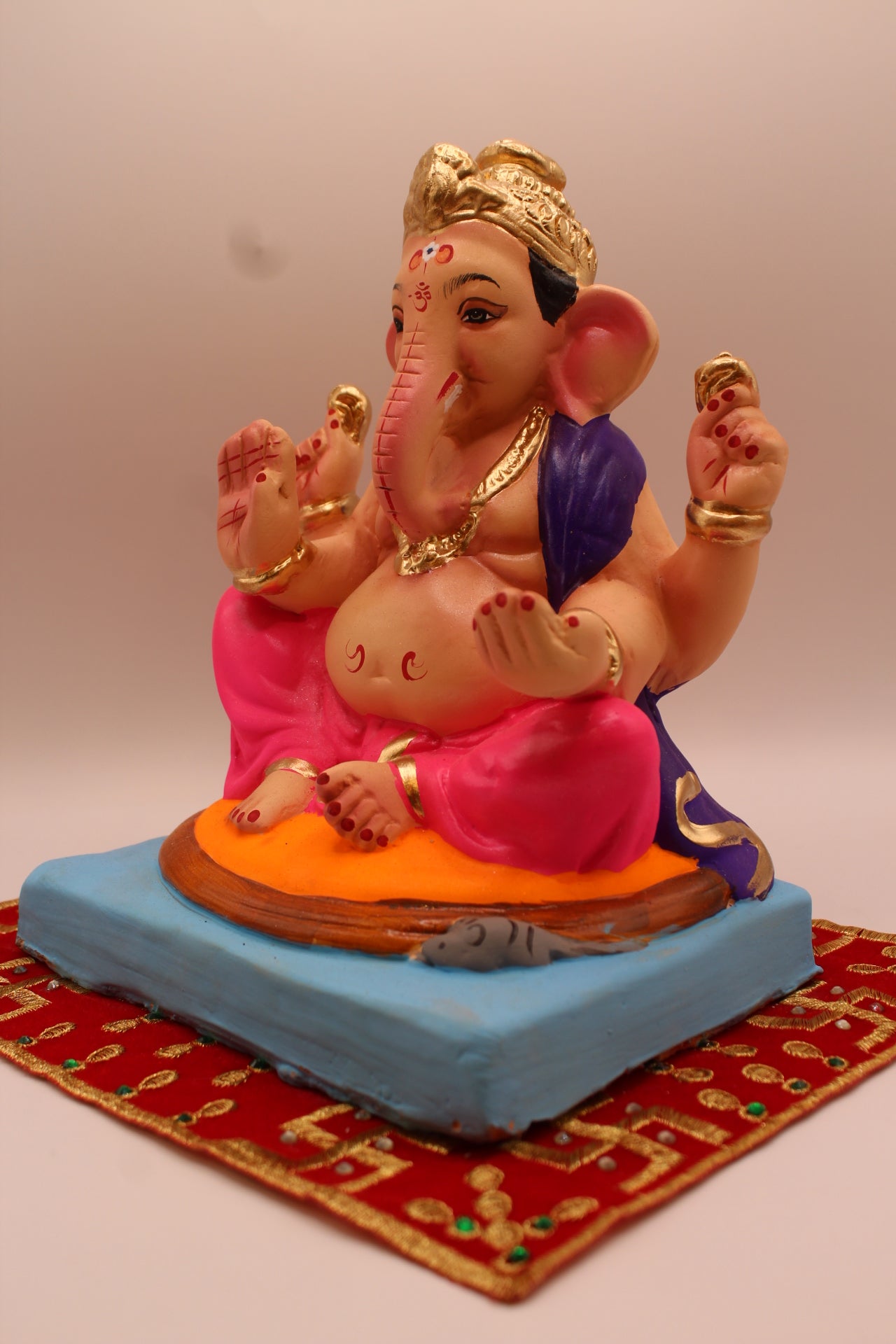 Eco-friendly 8 inch Ganesh Visarjan idol in purple shawl and rani pink dhoti – detail view