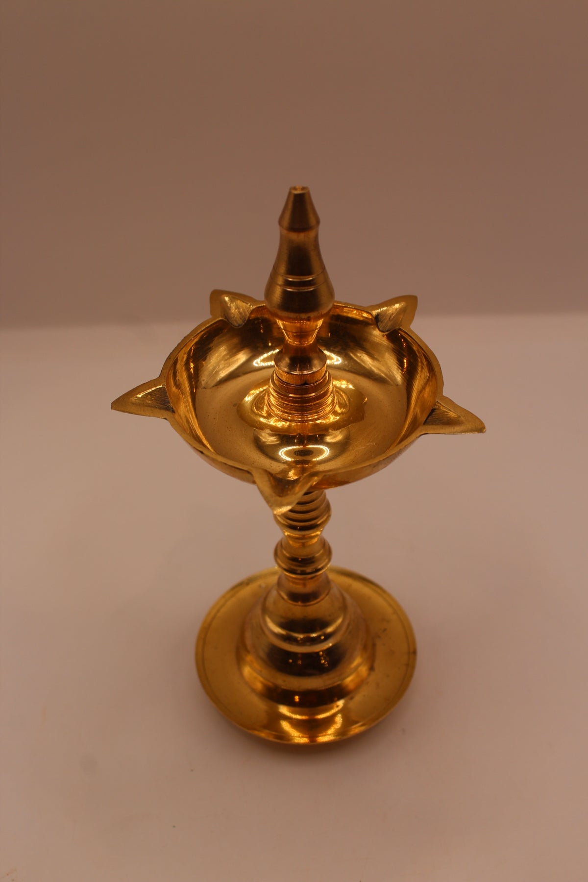 Wide brass samai diya stand, left side