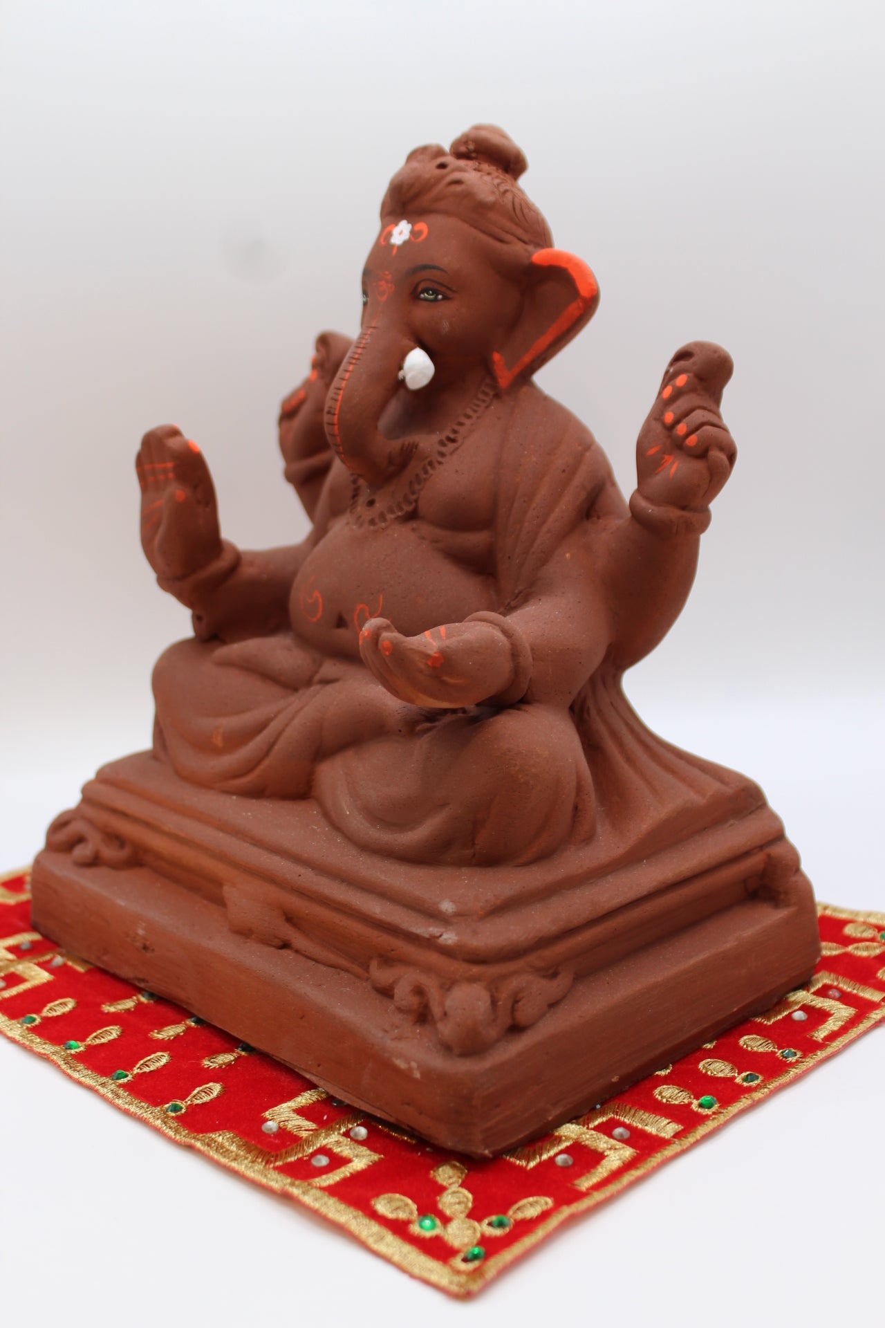 Natural terracotta eco-friendly 8 inch Ganesh Visarjan idol on pedestal base – detail view