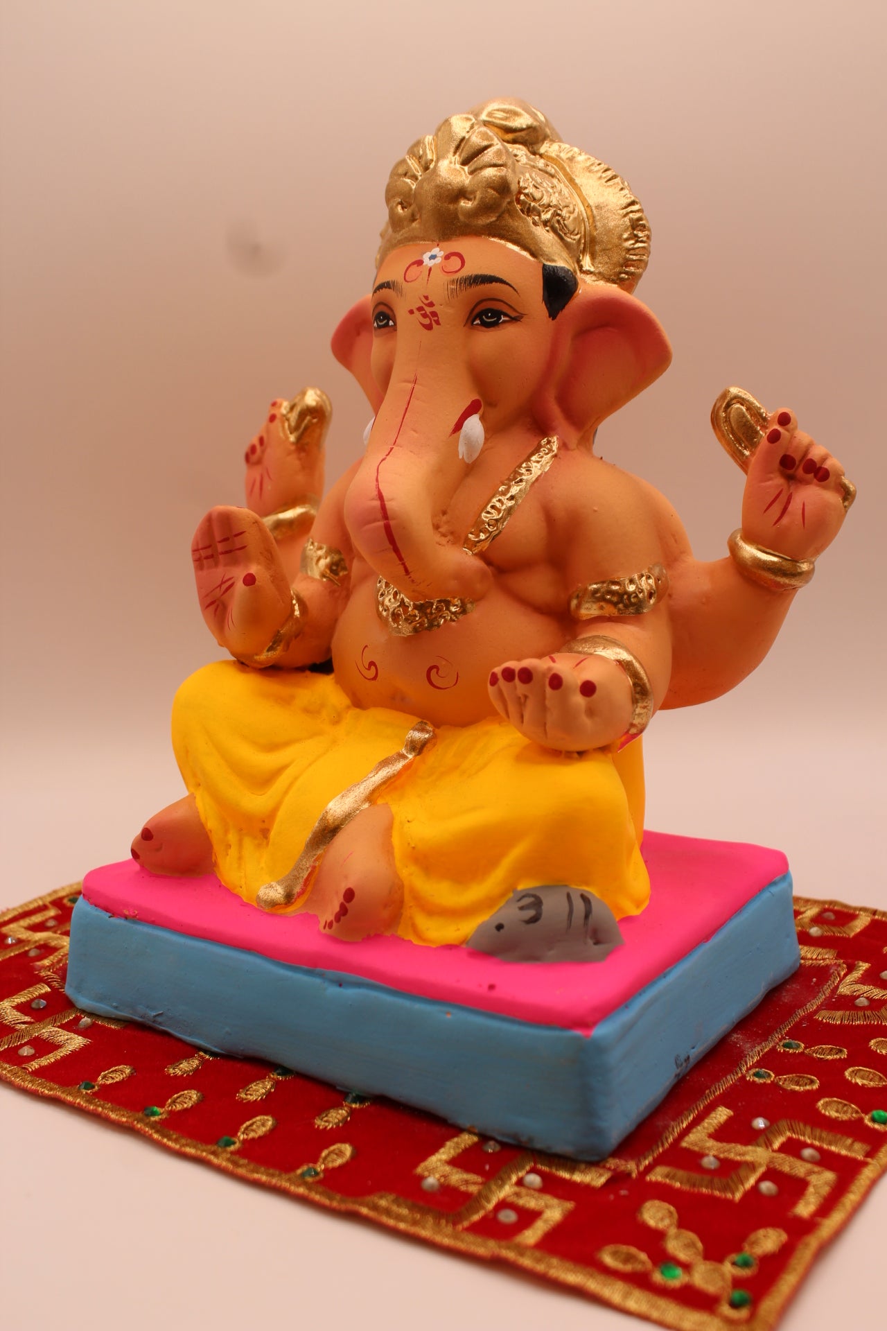 Eco-friendly 8 inch Ganesh Visarjan idol with yellow dhoti and gold fan crown – detail view