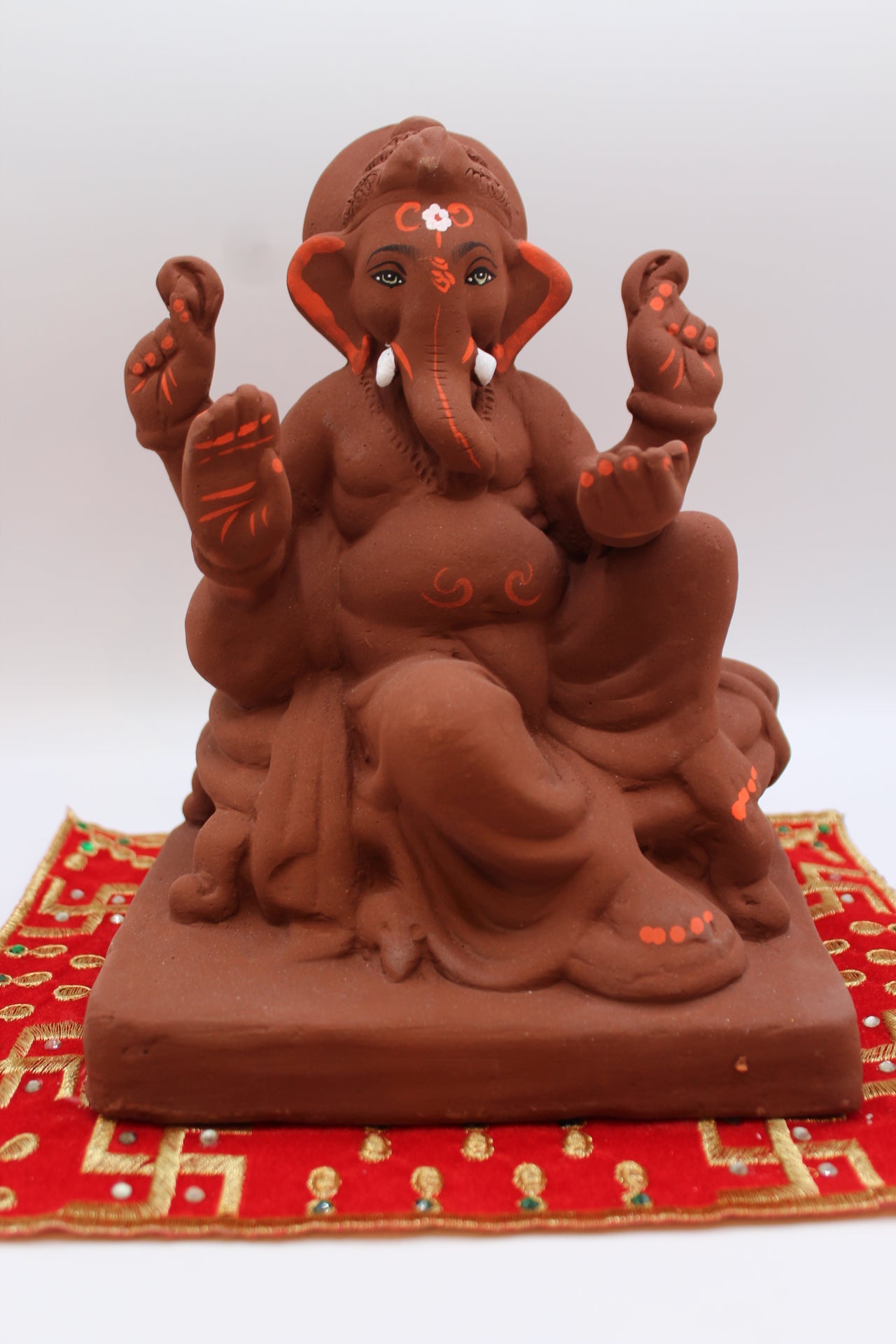 Natural terracotta eco-friendly 8 inch Ganesh Visarjan idol in royal seated pose – front view