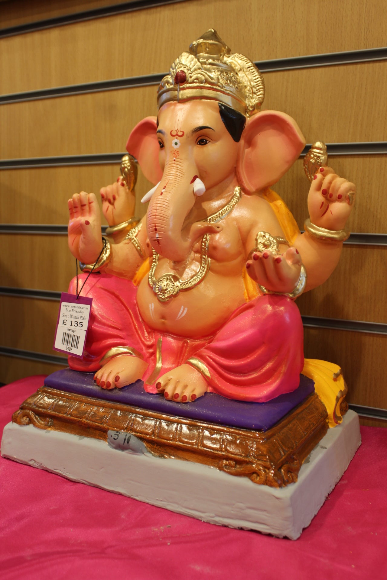 Angled view – saffron khes and rani pink dhoti on carved chowki