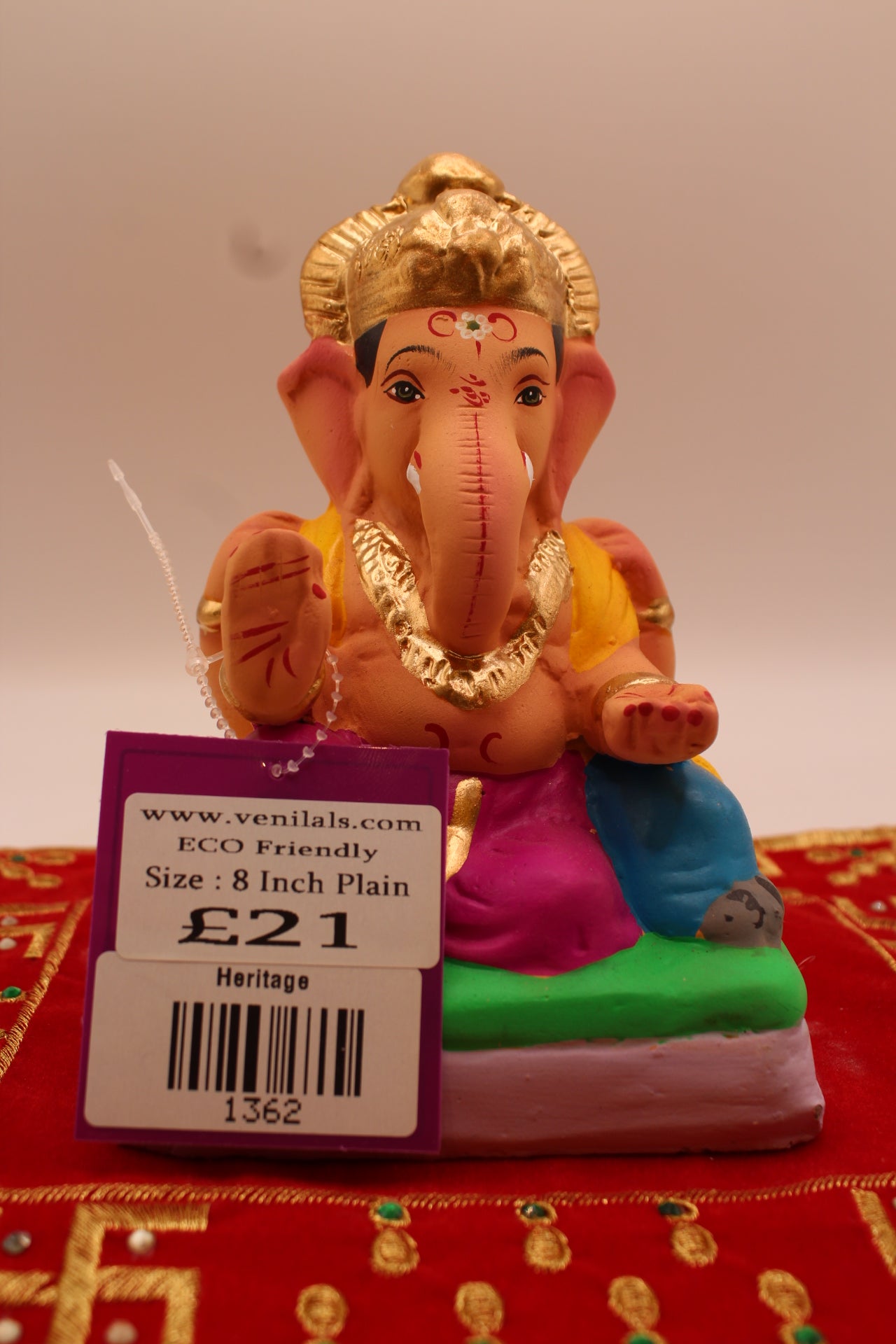 6 inch eco-friendly Ganesh idol, rani pink dhoti and marigold khes, front