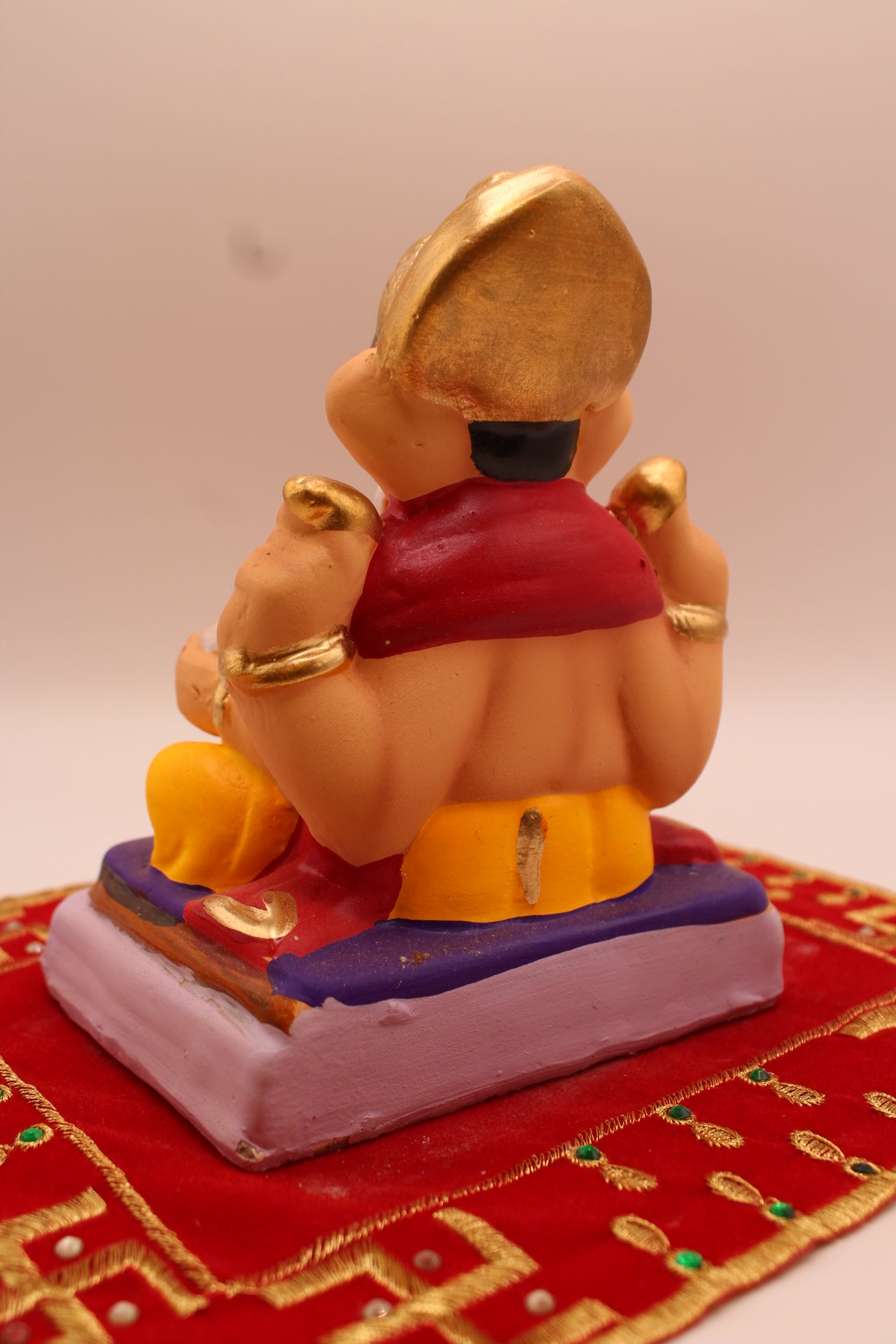 Back view showing the maroon khes sash