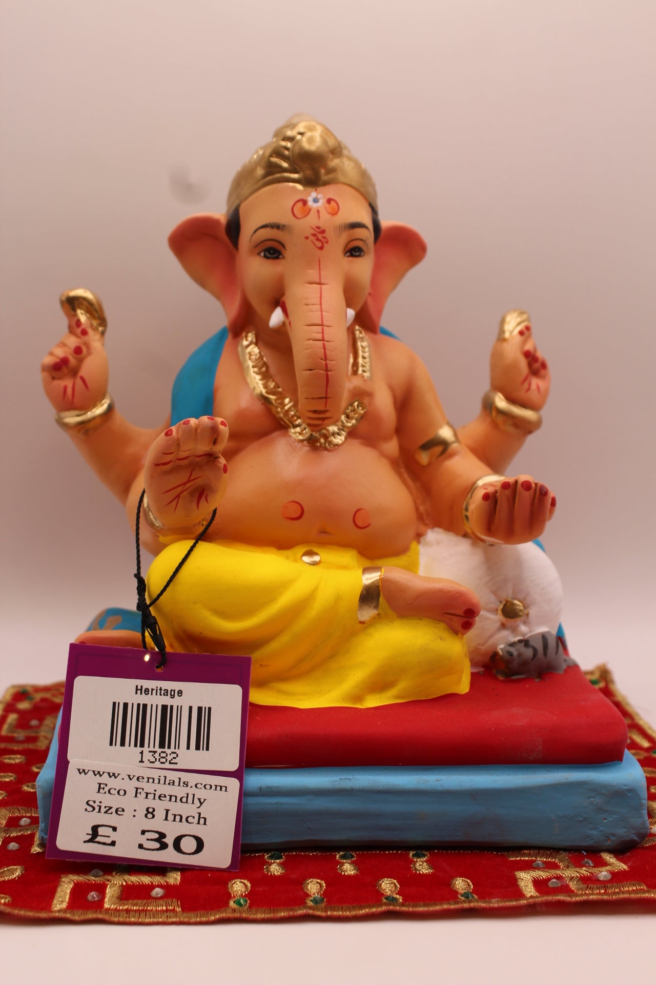 8 inch eco-friendly Ganesh idol – teal khes and yellow dhoti on a red cushion, front