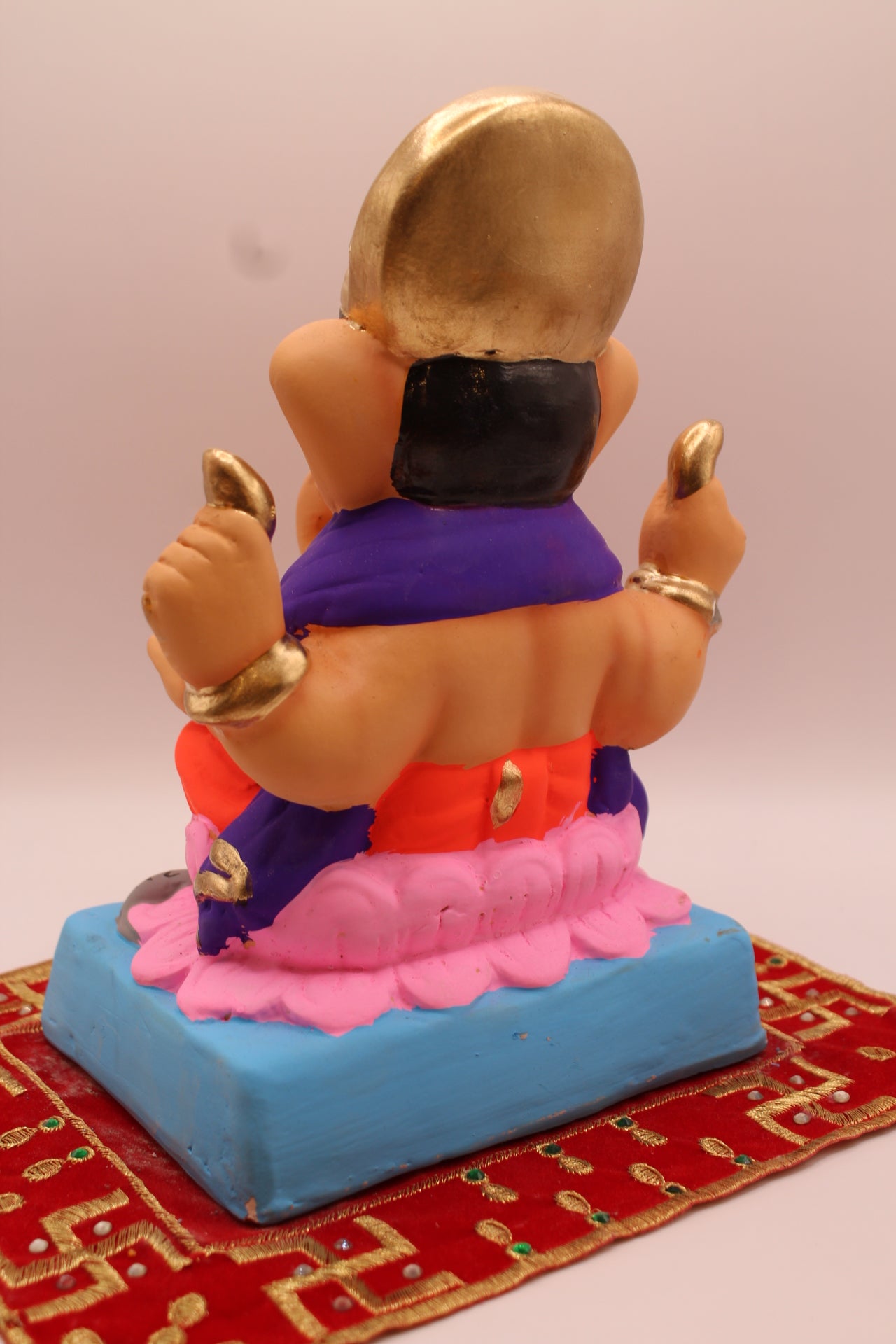 Back view – purple khes and orange dhoti on a pink lotus base