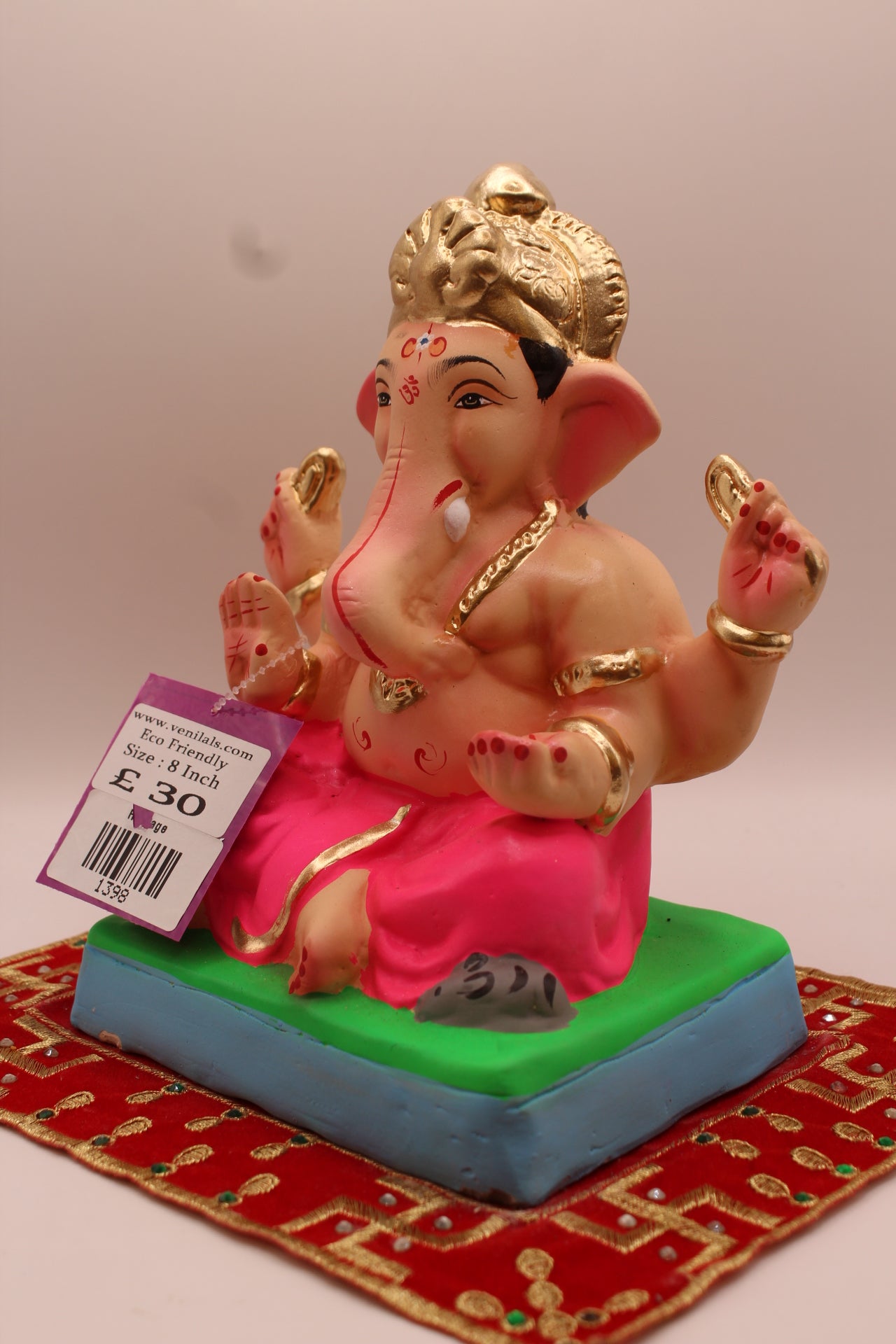 Angled view – all rani pink outfit with tall carved gold mukut