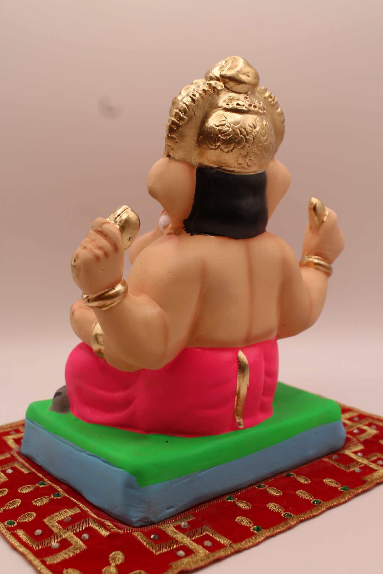 Back view – all rani pink outfit with tall carved gold mukut