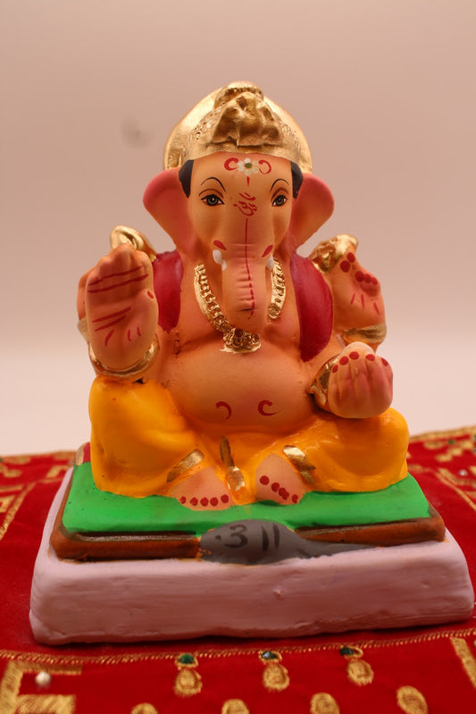 Eco-friendly 6 inch Ganesh idol, red khes and marigold dhoti, front view