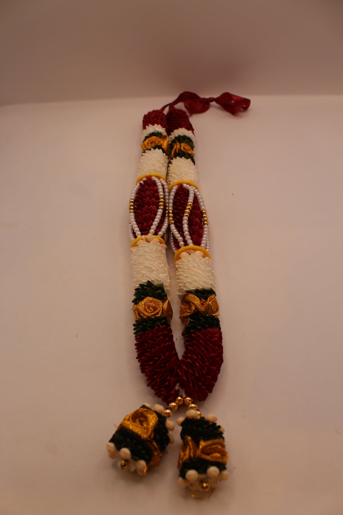 Maroon and white garland mala, close up