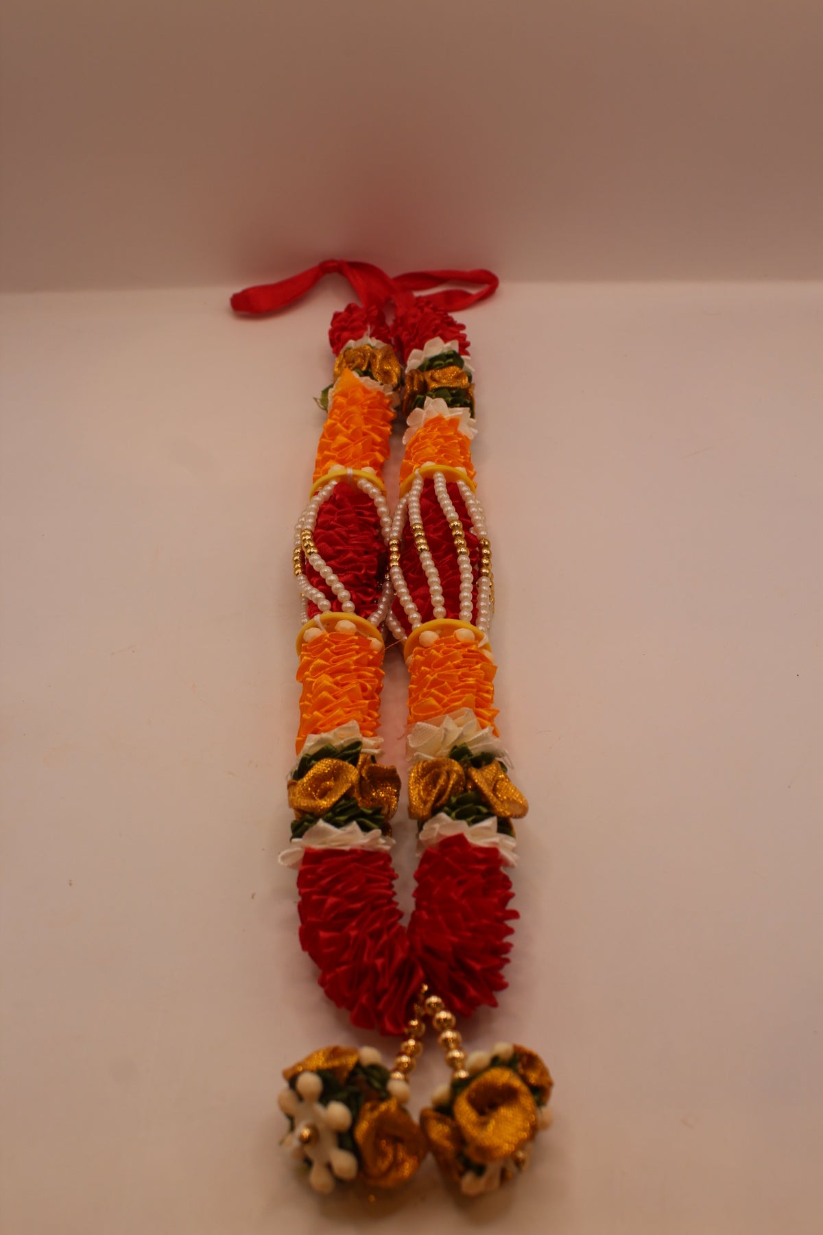 Orange and red garland mala, close up
