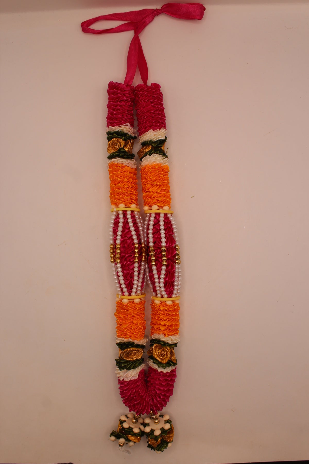 Pink and yellow garland mala laid flat