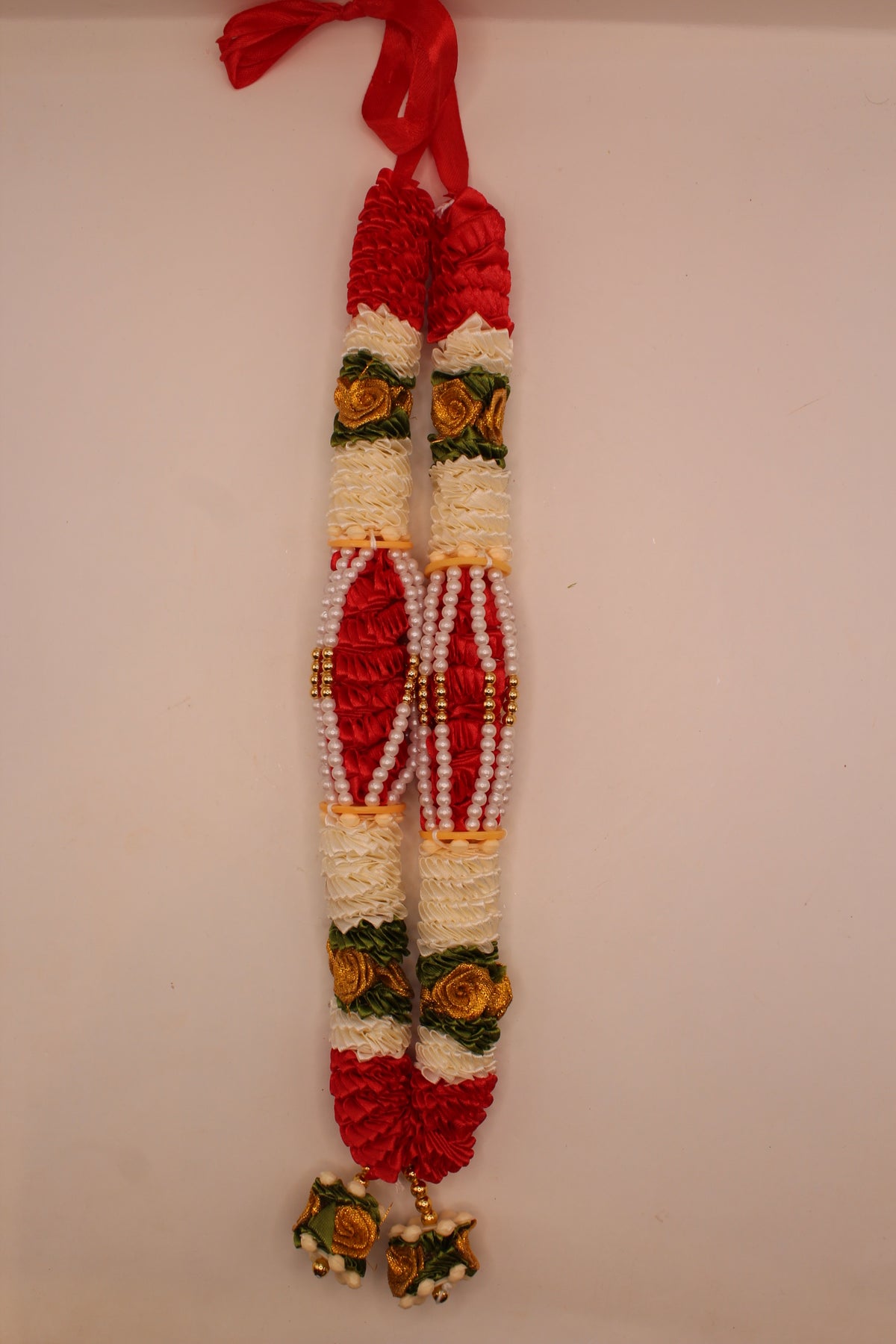 Red and white garland mala laid flat