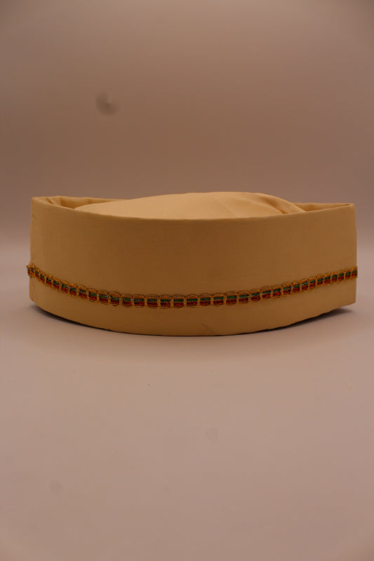 Cream Gandhi topi with gold braid trim, front view