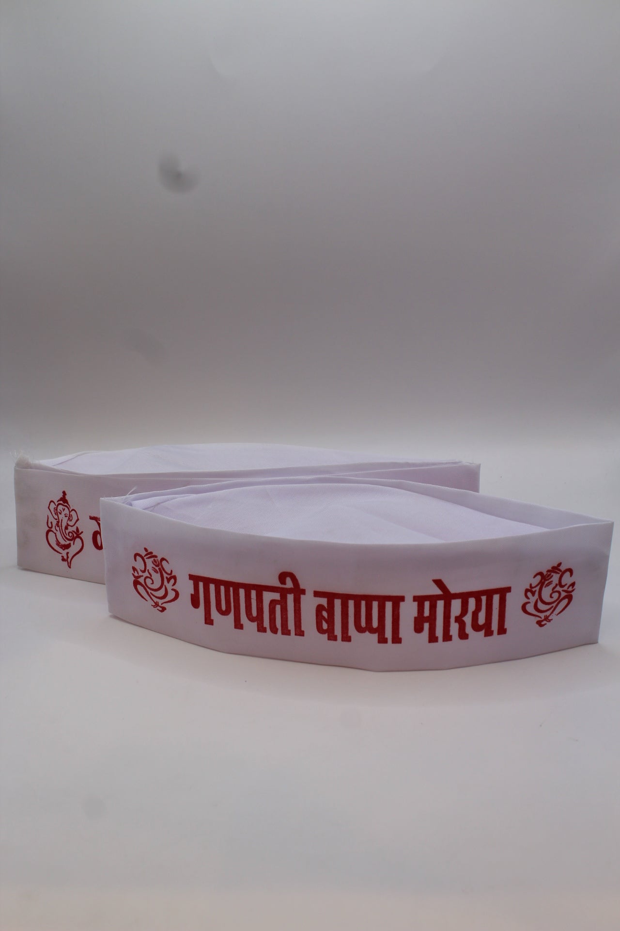 Gandhi topi with Ganpati Bappa Morya print, close-up of lettering