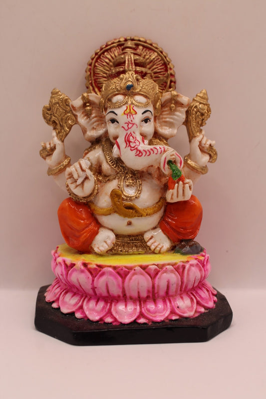 Resin Ganesh murti on pink lotus with orange dhoti, front view