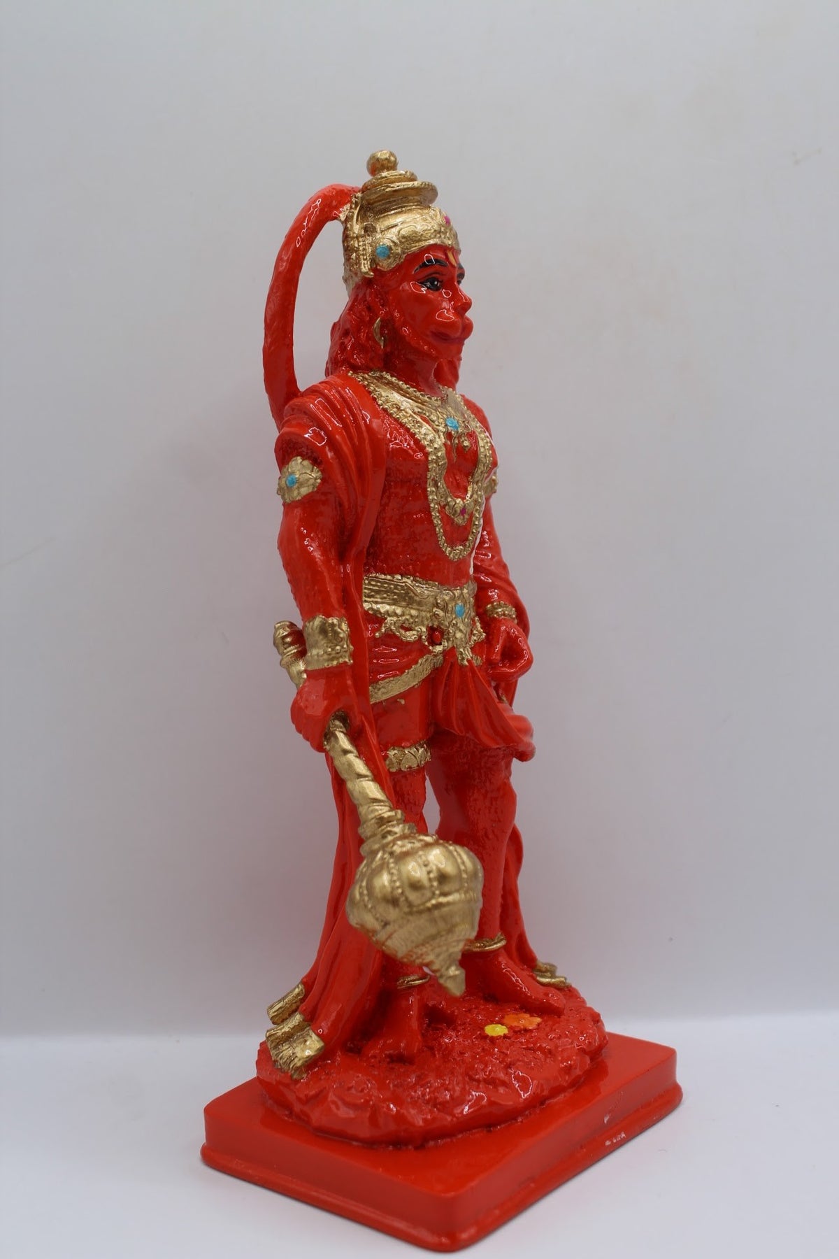 Orange resin Hanuman murti standing with gada, left side view