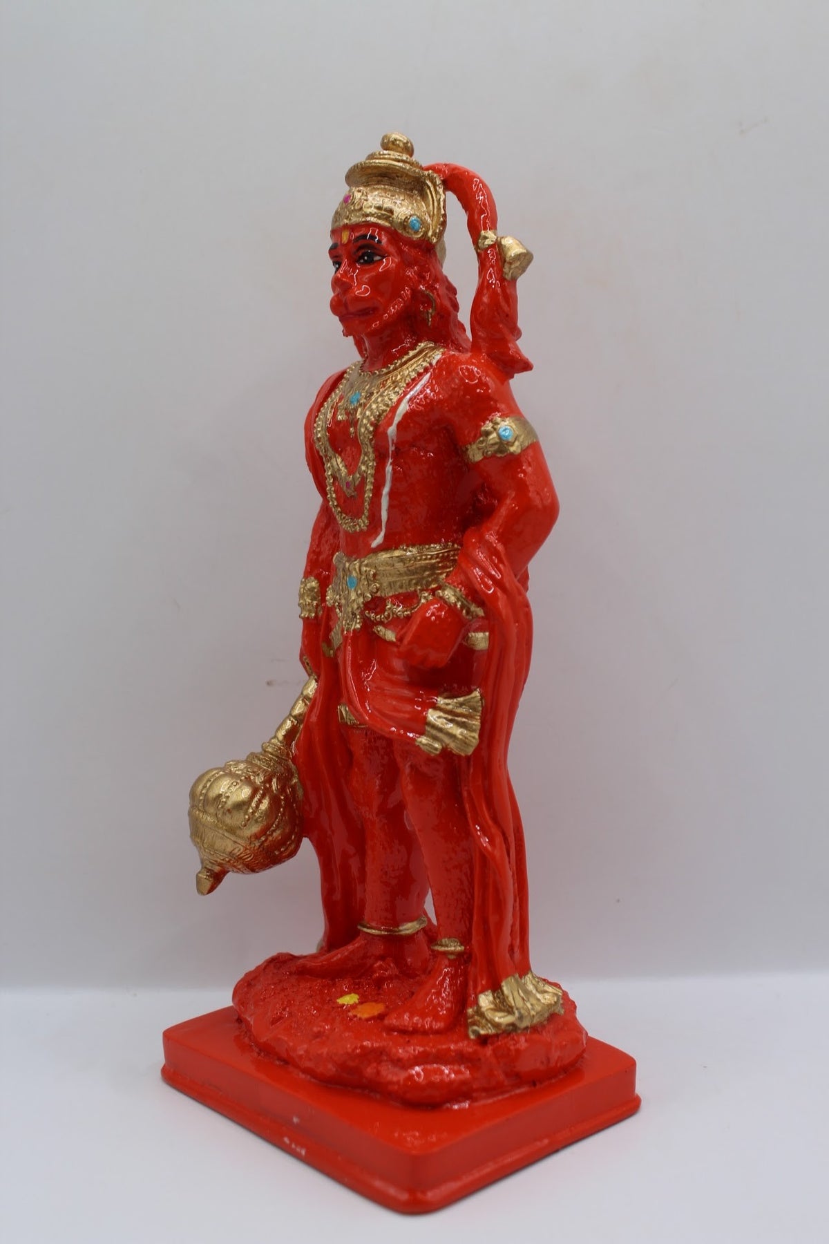 Orange resin Hanuman murti standing with gada, right side view