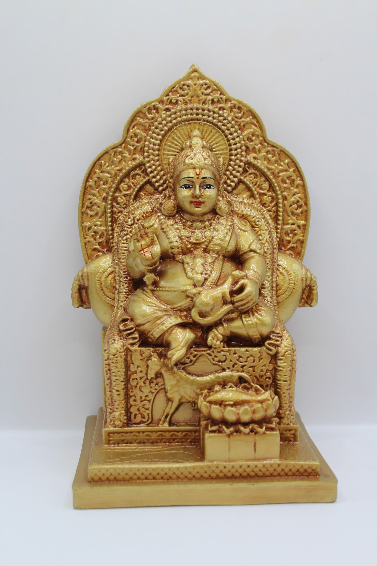 Gold resin Kuber murti seated on a throne, front view