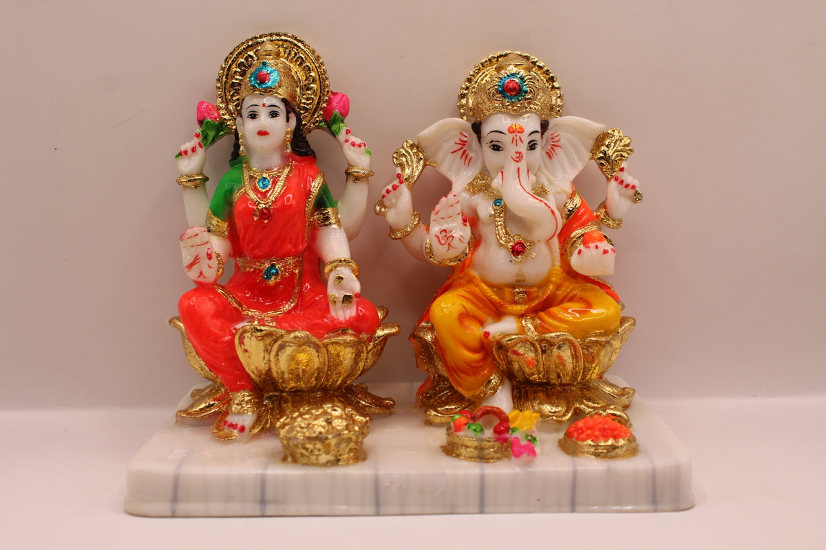 Resin Laxmi Ganesh murti pair on gold lotus seats with white base, front view