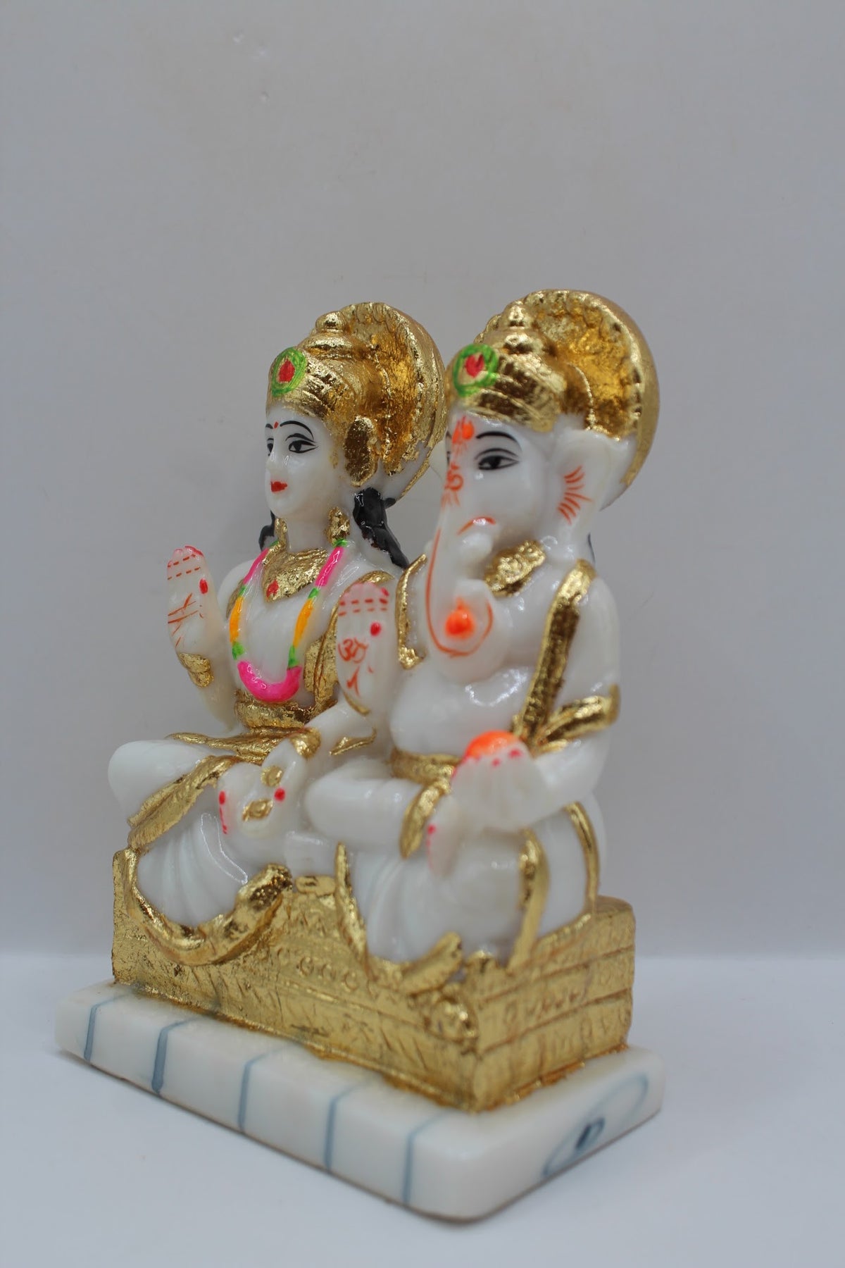 White and gold resin Laxmi Ganesh murti pair, right side view