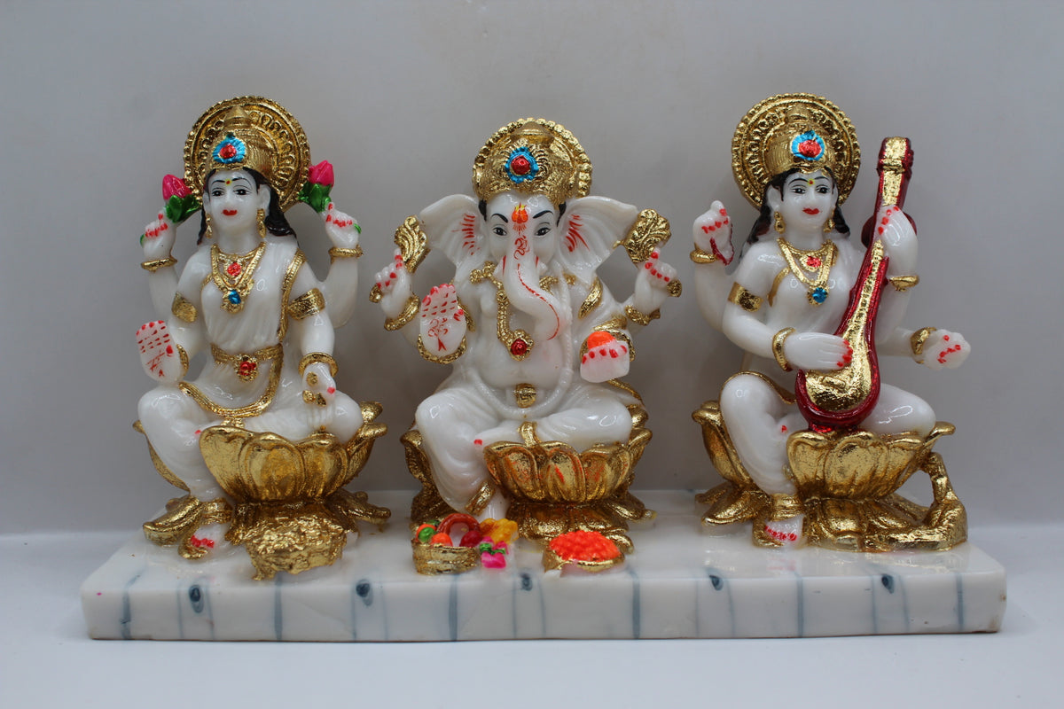 White and gold resin Laxmi Ganesh Saraswati murti trio, front view