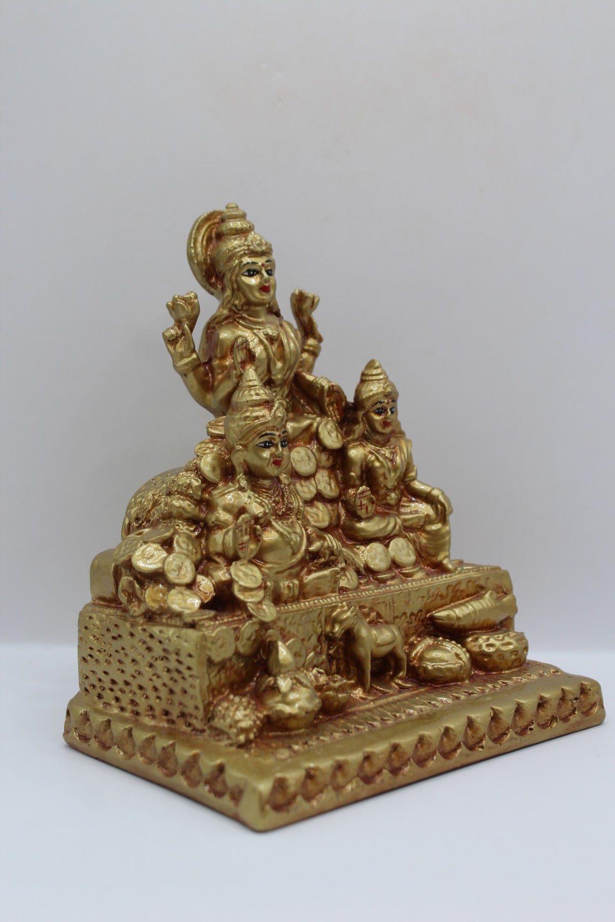 Gold resin Laxmi Kuber murti with coins, left side view