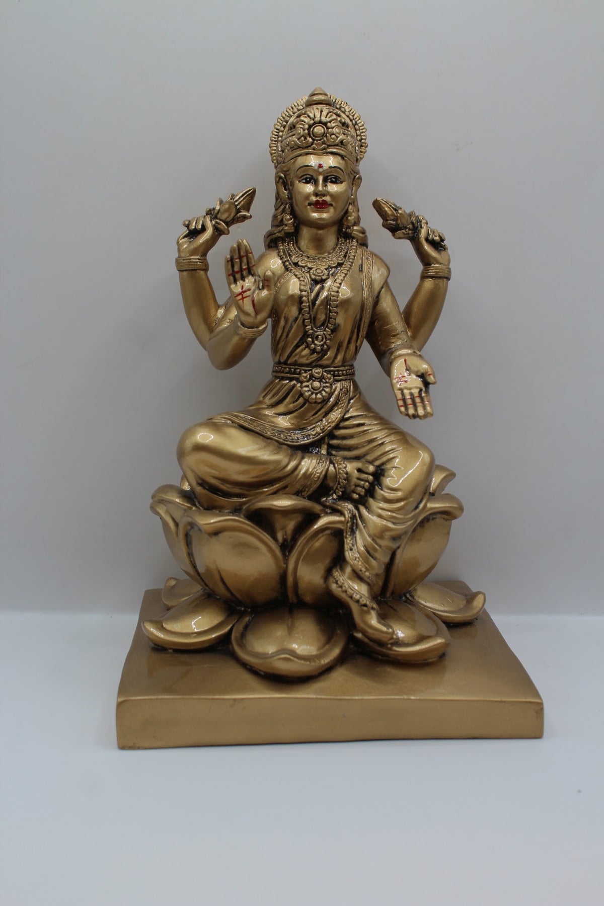 Antique gold resin Laxmi murti on a lotus, front view