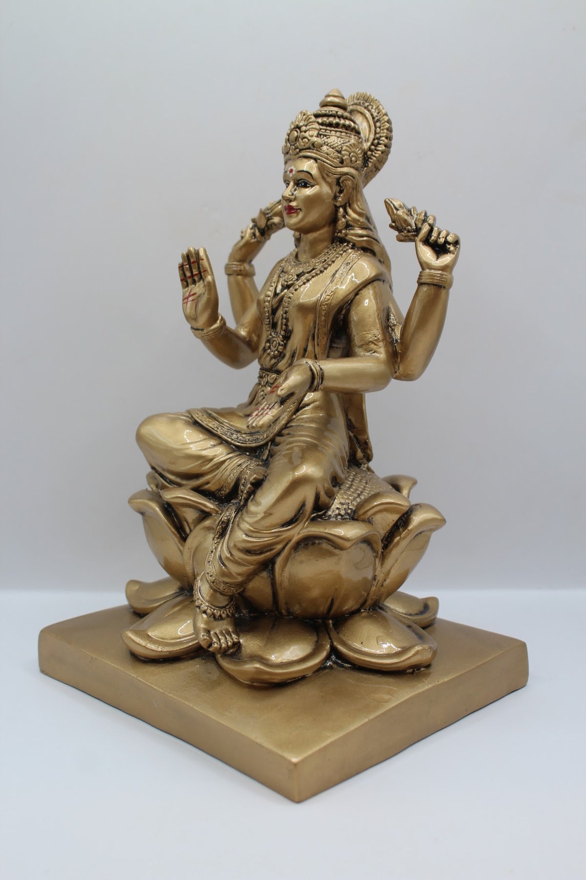 Antique gold resin Laxmi murti on a lotus, right side view