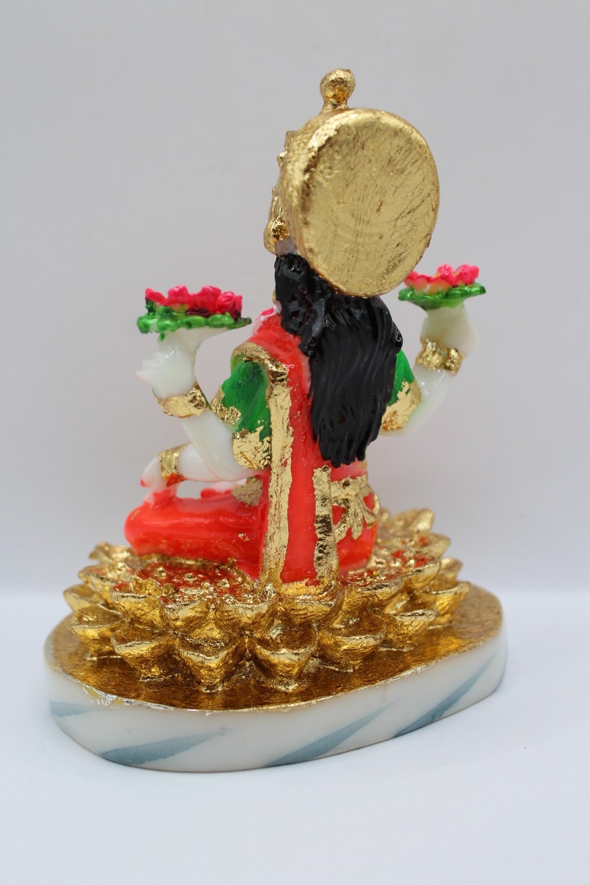 Resin Laxmi murti seated on gold coins, white base, back view