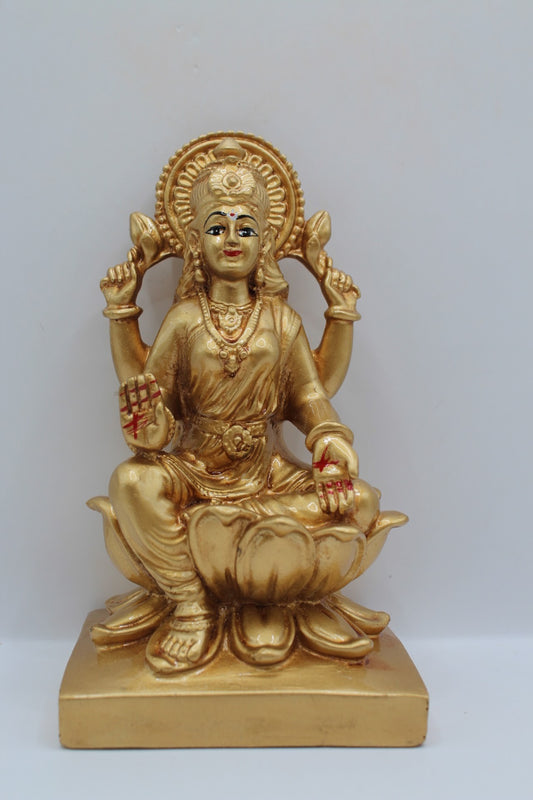 Gold resin Laxmi murti seated on a lotus, front view