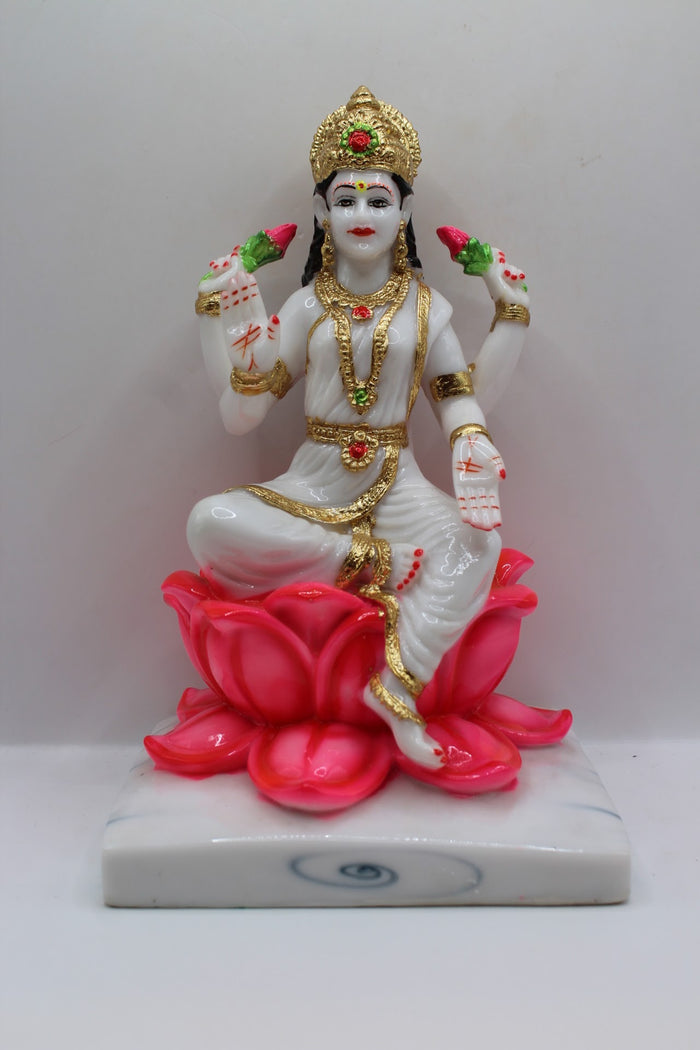 White and gold resin Laxmi murti on a pink lotus, front view