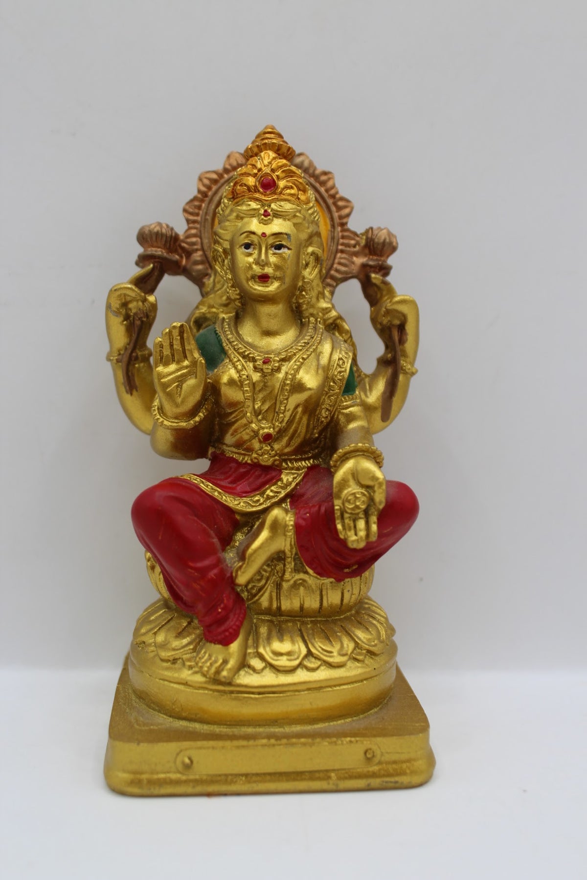 Small gold resin Laxmi murti with red clothes, front view