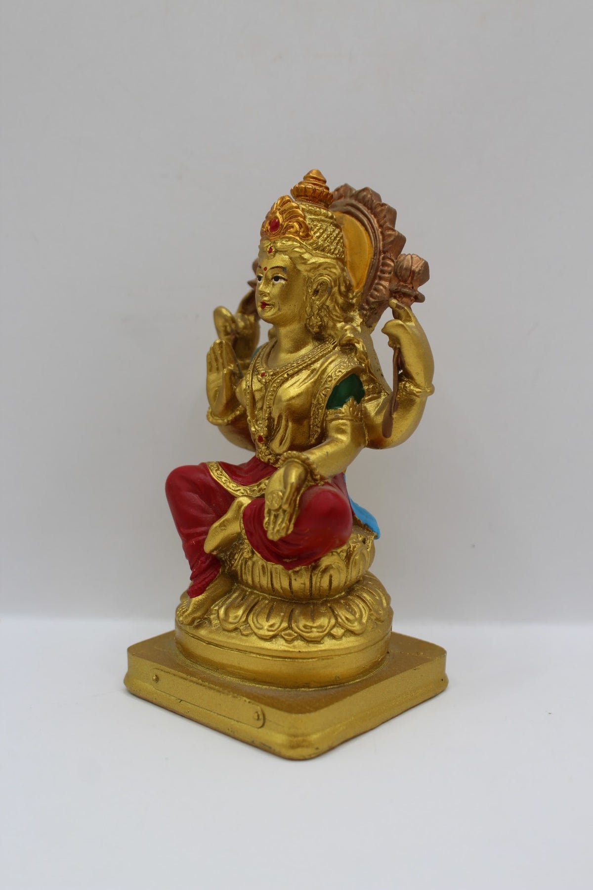 Small gold resin Laxmi murti with red clothes, right side view