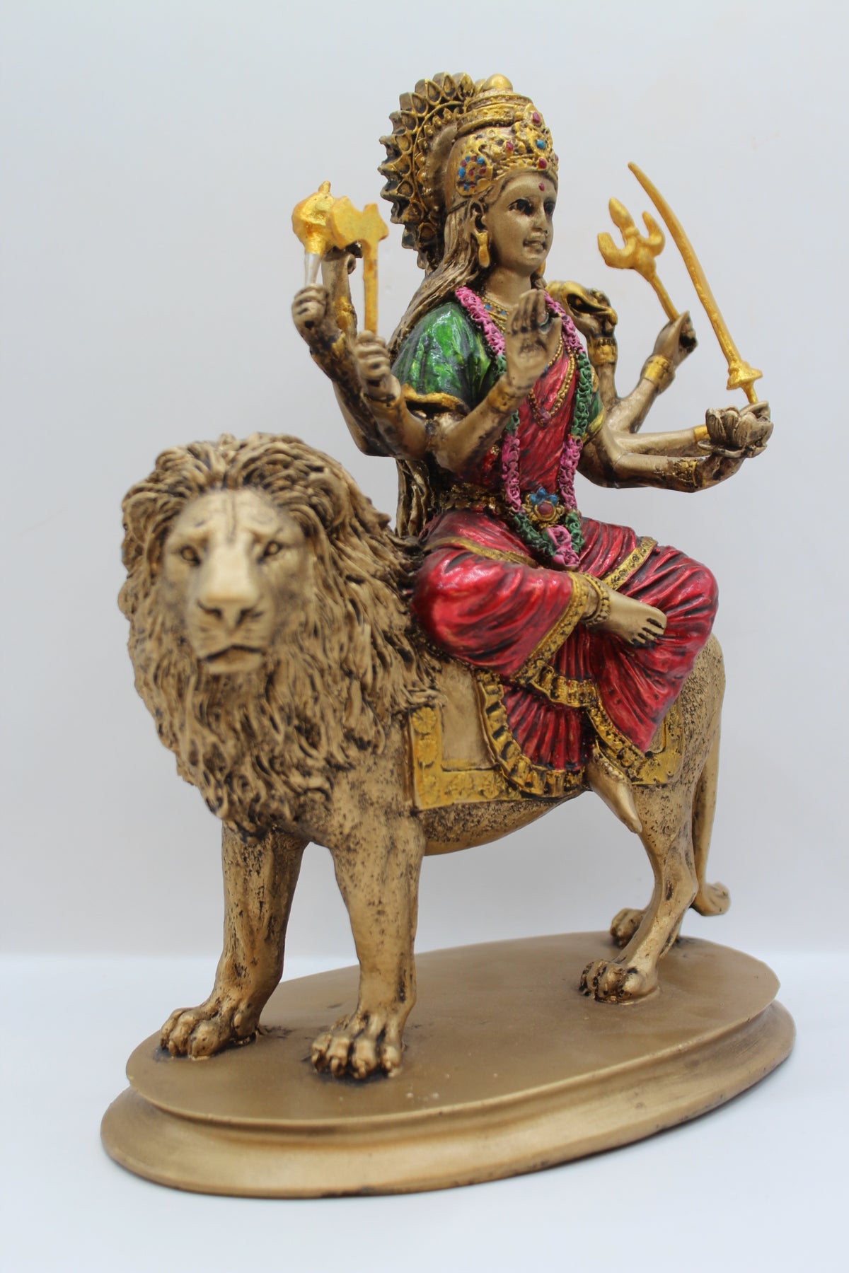 Resin Ambe Maa statue, seated on lion, antique bronze, left side view