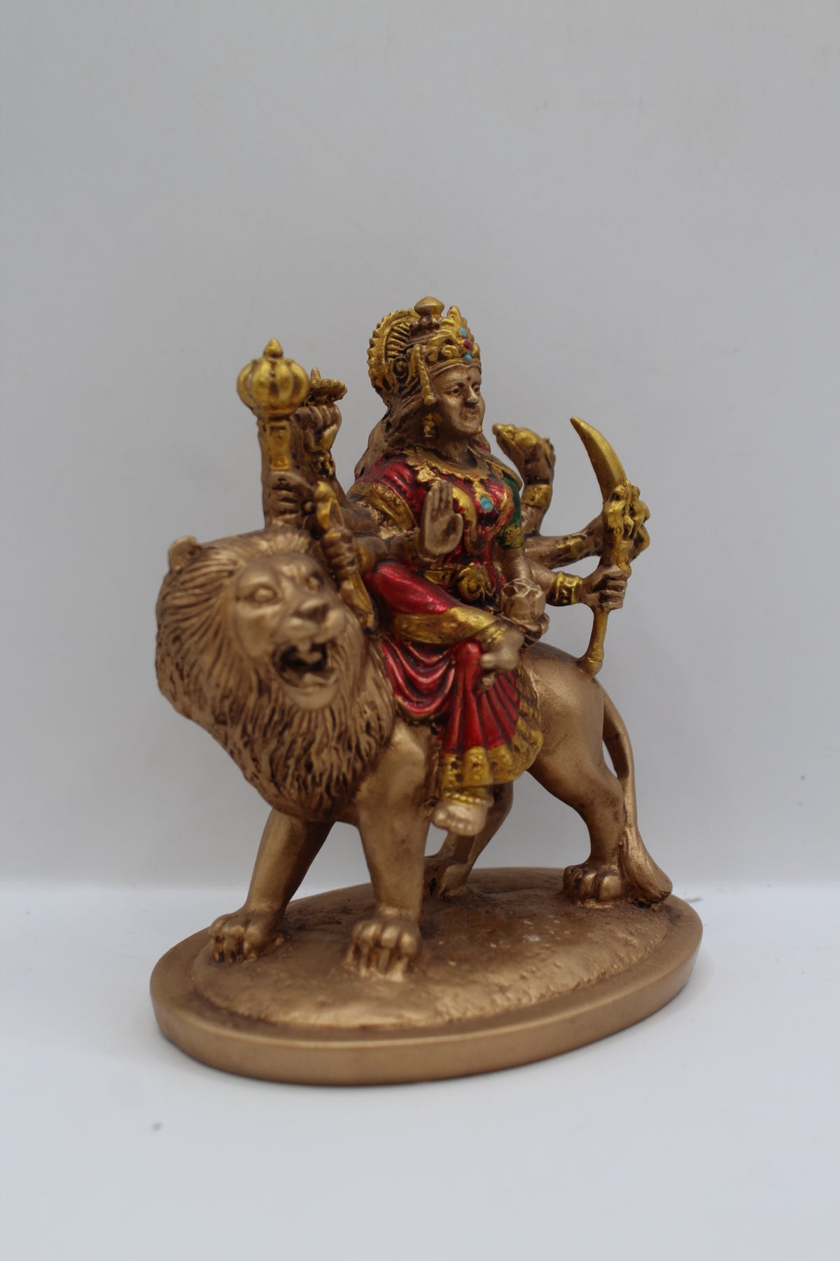Resin Ambe Maa statue, seated on lion, antique bronze, left side view