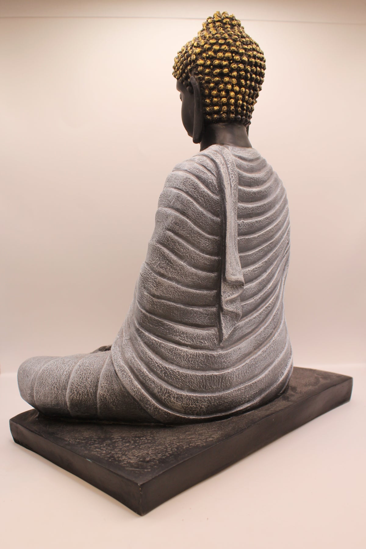 Charcoal grey Buddha statue on base, back