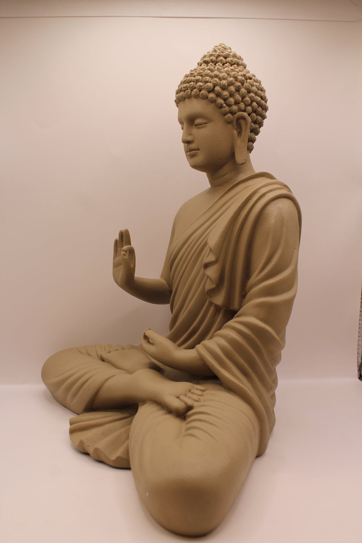 Light greige Buddha statue, right side
