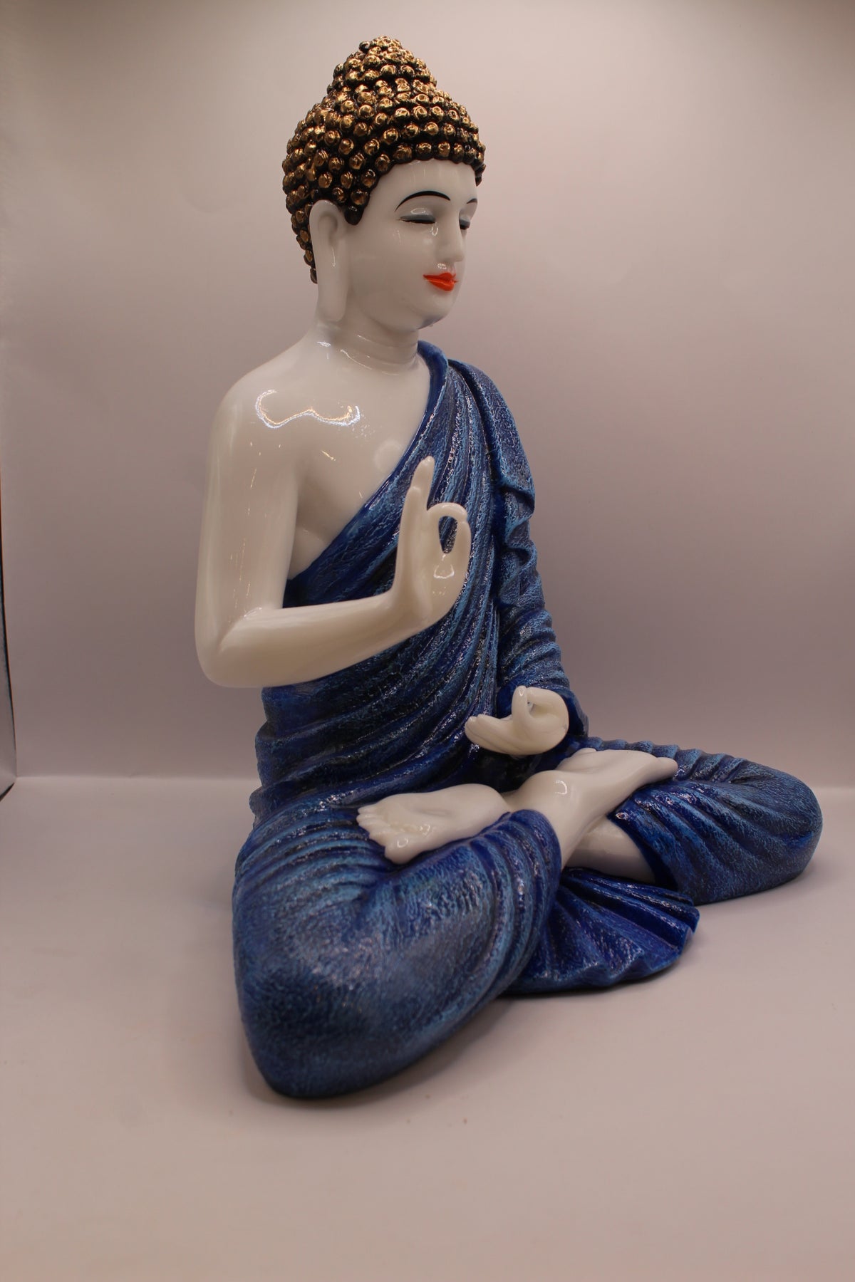 Pastel blue Buddha statue, left side