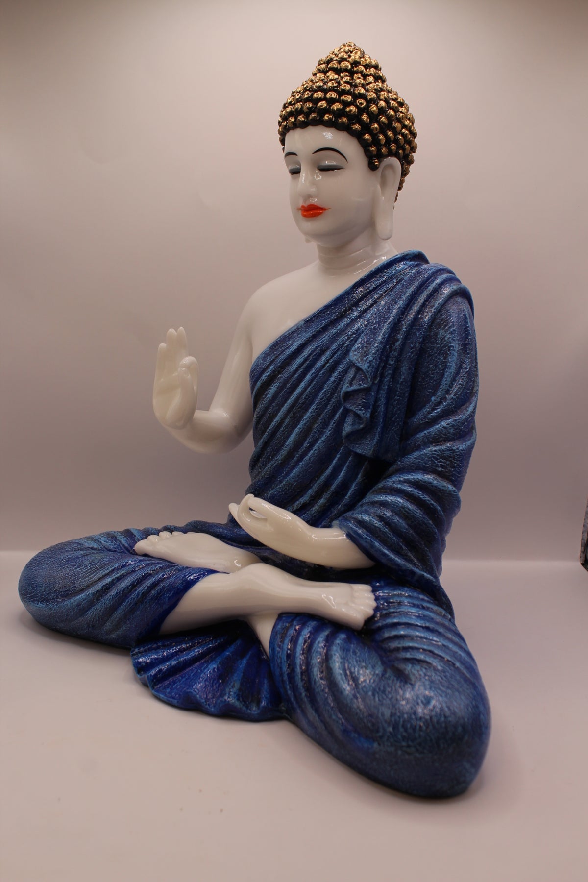 Pastel blue Buddha statue, right side